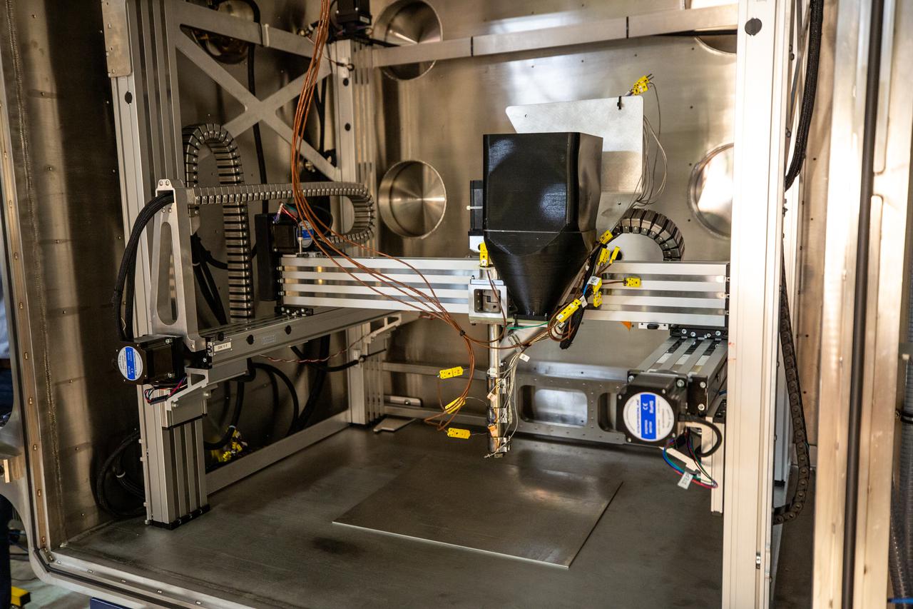 A team of engineers and researchers prepares a vacuum chamber in the Granular Mechanics and Regolith Operations (GMRO) lab inside NASA Kennedy Space Center’s Swamp Works for testing 3D printing, as part of the Relevant Environment Additive Construction Technology (REACT) project at the Florida spaceport on April 5, 2022. The project derives from NASA’s 2020 Announcement of Collaboration Opportunity, with AI SpaceFactory – an architectural and construction technology company and winner of NASA’s 3D Printed Habitat Challenge – collaborating with Kennedy teams to build 3D-printed test structures using a composite made from polymers and a regolith simulant in a vacuum chamber that mimics environmental conditions on the Moon. 