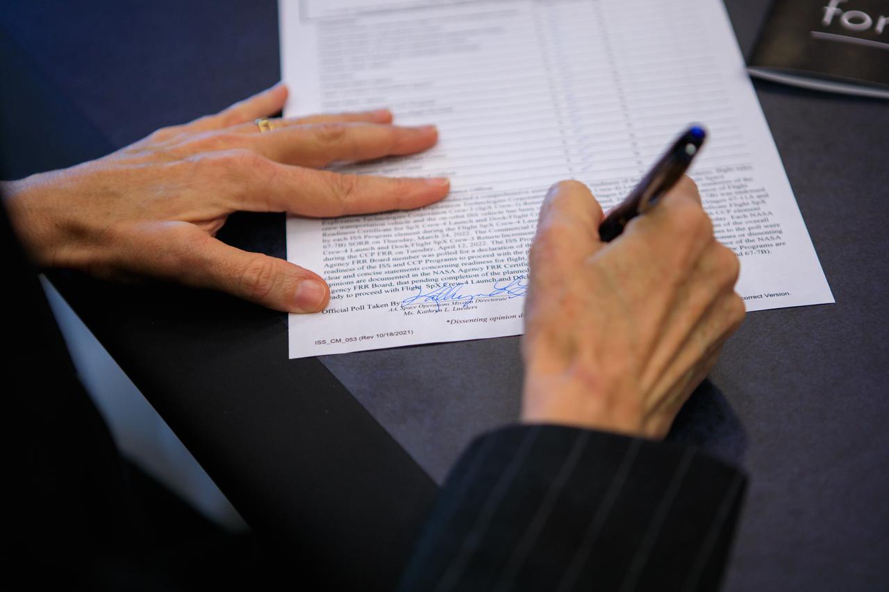 Kathy Lueders, associate administrator, Space Operations Mission Directorate, NASA Headquarters, signs a document during the Flight Readiness Review for the agency’s SpaceX Crew-4 mission at the agency’s Kennedy Space Center in Florida on April 15, 2022. International partners also participated. NASA and SpaceX mission managers held the review to confirm the SpaceX Falcon 9 rocket and Crew Dragon spacecraft are ready for launch. Crew-4 is scheduled to launch to the International Space Station from Kennedy’s Launch Complex 39A on April 23, 2022, as part of NASA’s Commercial Crew Program. Liftoff of the Falcon 9 rocket and Crew Dragon spacecraft is targeted for 5:26 a.m. EDT.