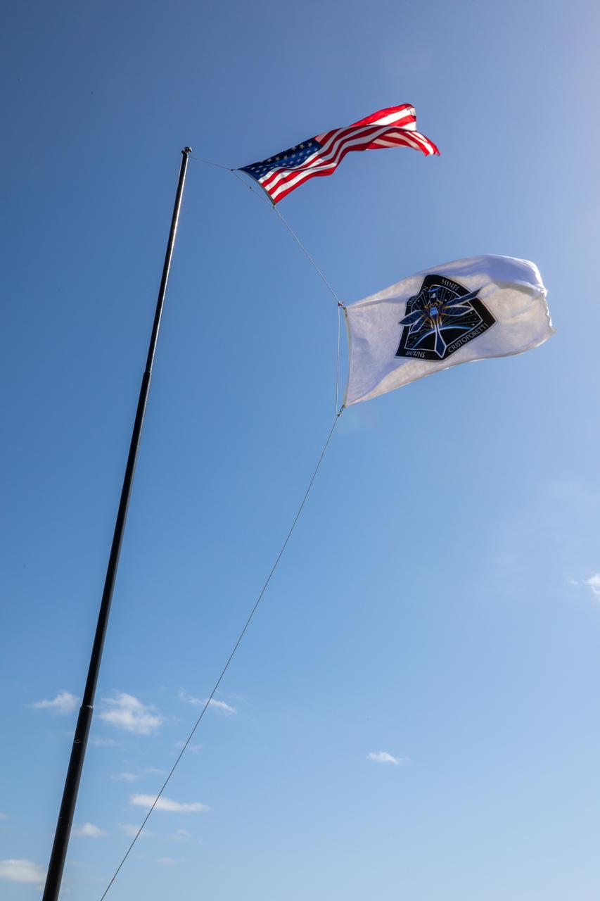 NASA’s SpaceX Crew-4 flag is raised near the News Center countdown clock at NASA’s Kennedy Space Center in Florida on April 19, 2022. The SpaceX Falcon 9 with Crew Dragon, named Freedom by the Crew-4 crew, atop is scheduled to lift off Saturday, April 23, 2002, at 5:26 p.m. EDT, from Launch Complex 39A at Kennedy. Dragon will carry NASA astronauts Kjell Lindgren, Bob Hines, and Jessica Watkins, and ESA (European Space Agency) astronaut Samantha Cristoforetti to the International Space Station as part of NASA’s Commercial Crew Program.