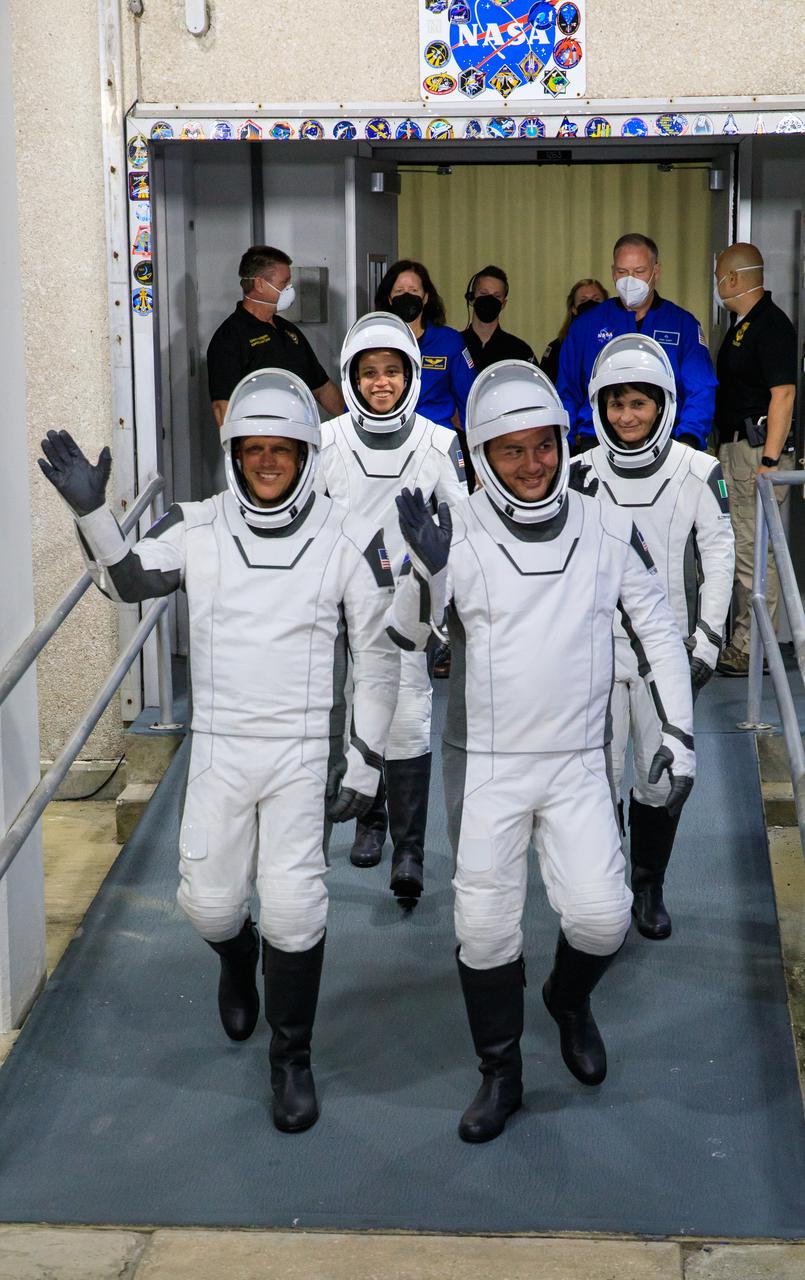 NASA’s SpaceX Crew-4 astronauts – from front, left to right – Bob Hines, Kjell Lindgren, Jessica Watkins, and Samantha Cristoforetti walk out through the double doors below the Neil A. Armstrong Building’s Astronaut Crew Quarters at NASA’s Kennedy Space Center in Florida for a dry dress rehearsal on April 20, 2022. SpaceX’s Falcon 9 rocket and Crew Dragon, named Freedom by the Crew-4 crew, will launch the astronauts to the International Space Station as part of NASA’s Commercial Crew Program. Liftoff is targeted for 5:26 a.m. EDT on Saturday, April 23, 2022, from Launch Complex 39A at Kennedy.