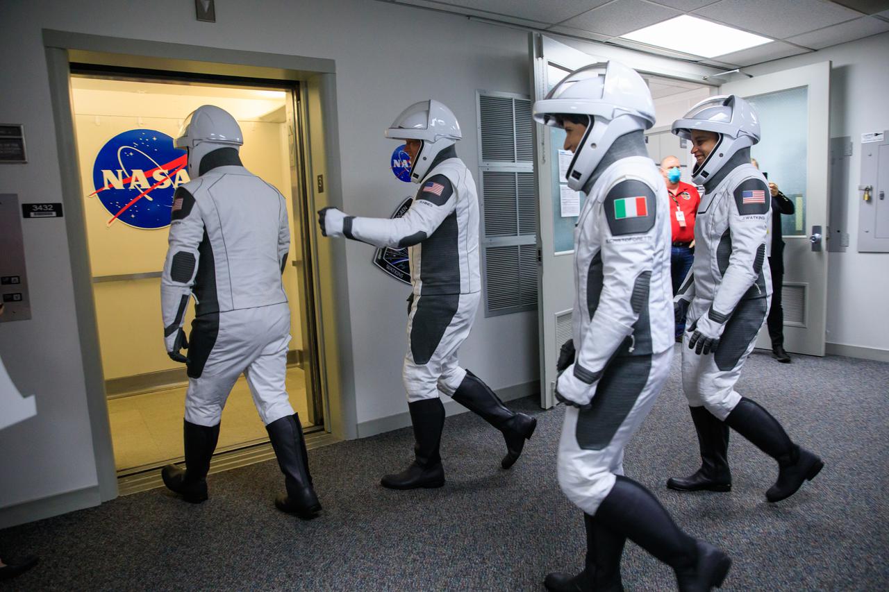Crew-4 mission astronauts Bob Hines, Kjell Lindgren, Jessica Watkins, and Samantha Cristoforetti walk out of the Astronaut Crew Quarters inside Kennedy Space Center’s Neil A. Armstrong Operations and Checkout Building during a dry dress rehearsal on April 20, 2022. A team of SpaceX suit technicians assisted them as they put on their custom-fitted spacesuits and checked the suits for leaks. SpaceX’s Falcon 9 rocket and Crew Dragon, named Freedom by the Crew-4 crew, will launch the astronauts to the International Space Station as part of NASA’s Commercial Crew Program. The mission is scheduled to lift off at 5:26 a.m. EDT on April 23, 2022, from Launch Complex 39A at Kennedy.