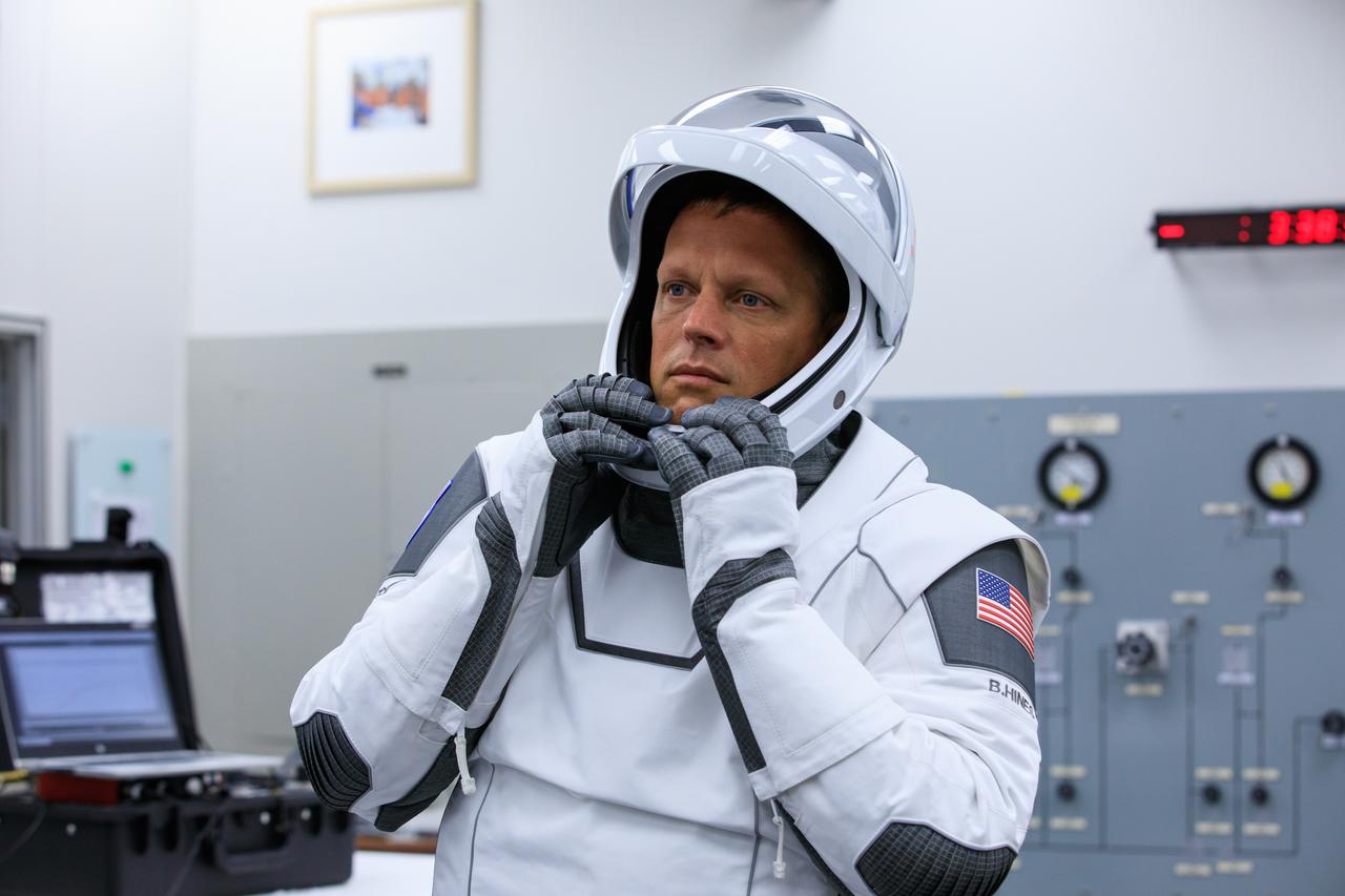 NASA astronaut Bob Hines adjusts his helmet in the suit room inside Kennedy Space Center’s Neil A. Armstrong Operations and Checkout Building during NASA’s SpaceX Crew-4 dry dress rehearsal on April 20, 2022. Hines, along with fellow Crew-4 astronauts Kjell Lindgren, Jessica Watkins, and Samantha Cristoforetti, is scheduled to lift off from Kennedy’s Launch Complex 39A at 5:26 a.m. EDT on April 23, 2022. SpaceX’s Falcon 9 rocket and Crew Dragon, named Freedom by the Crew-4 crew, will launch the astronauts to the International Space Station as part of NASA’s Commercial Crew Program.