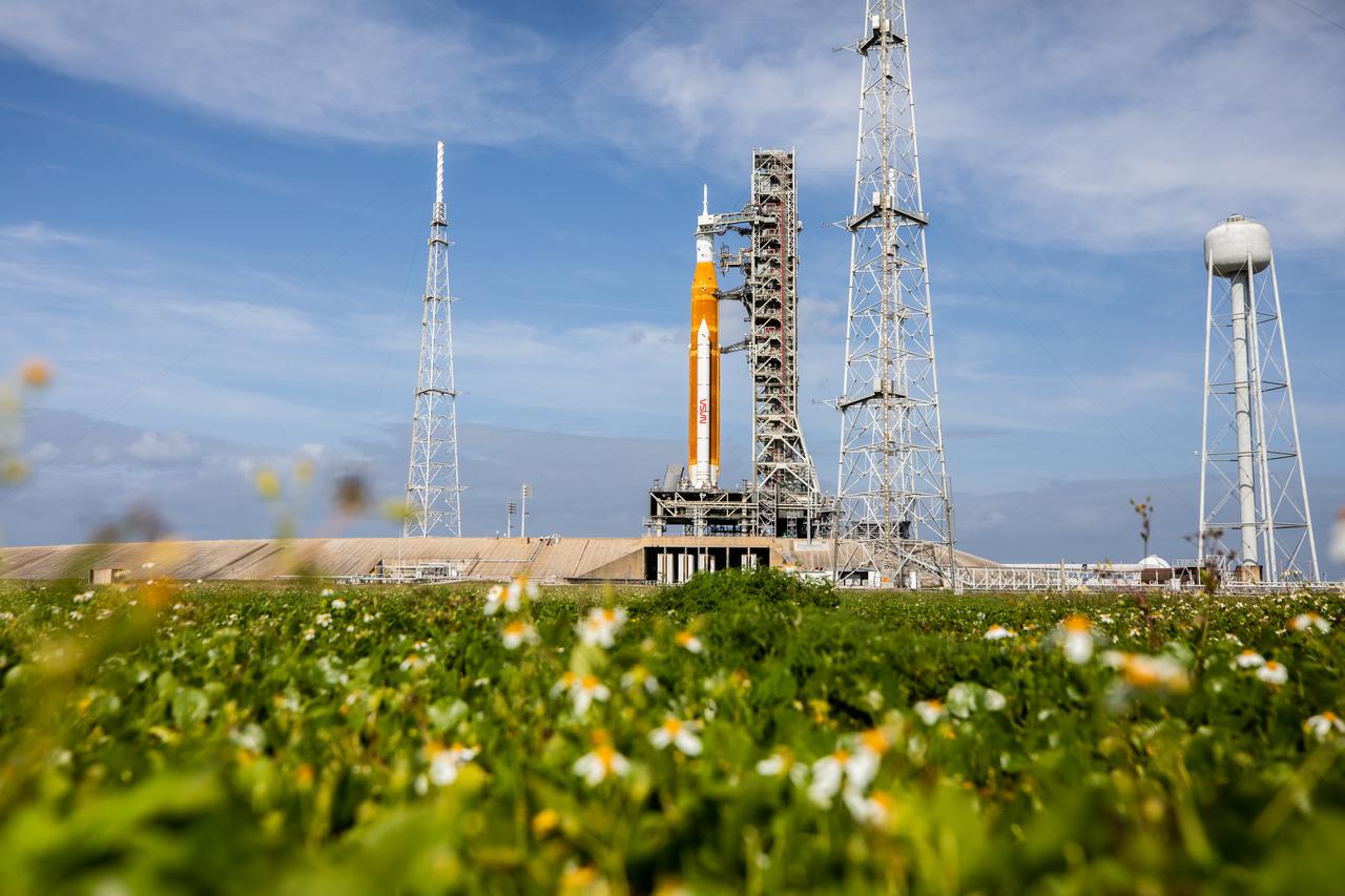 A view of the Artemis I Space Launch System (SLS) and Orion spacecraft on Launch Pad 39B at NASA’s Kennedy Space Center in Florida on April 21, 2022. The SLS and Orion atop the mobile launcher were transported to the pad on crawler-transporter 2 for a prelaunch test called a wet dress rehearsal. Artemis I will be the first integrated test of the SLS and Orion spacecraft. In future Artemis missions, NASA will land the first woman and the first person of color on the surface of the Moon, paving the way for a long-term lunar presence and serving as a steppingstone on the way to Mars.