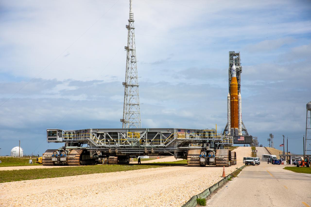 Crawler-transporter 2 (CT-2) makes its way along the crawlerway to Launch Complex 39B at NASA’s Kennedy Space Center in Florida on April 21, 2022. In view atop the mobile launcher on the pad are the Artemis I Space Launch System (SLS) and Orion spacecraft. The SLS and Orion atop the mobile launcher were transported to the pad on CT-2 for a prelaunch test called a wet dress rehearsal. Artemis I will be the first integrated test of the SLS and Orion spacecraft. In future Artemis missions, NASA will land the first woman and the first person of color on the surface of the Moon, paving the way for a long-term lunar presence and serving as a steppingstone on the way to Mars.