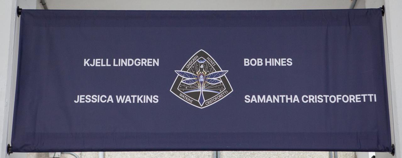 A banner hangs outside the Neil A. Armstrong Operations and Checkout Building at NASA’s Kennedy Space Center in Florida on April 27, 2022. Crew-4 astronauts Kjell Lindgren, Bob Hines, Jessica Watkins, and Samantha Cristoforetti will launch to the International Space Station aboard SpaceX’s Crew Dragon, powered by the company’s Falcon 9 rocket, as part of NASA’s Commercial Crew Program. Liftoff is scheduled for today at 3:52 a.m. EDT from Launch Complex 39A at Kennedy.