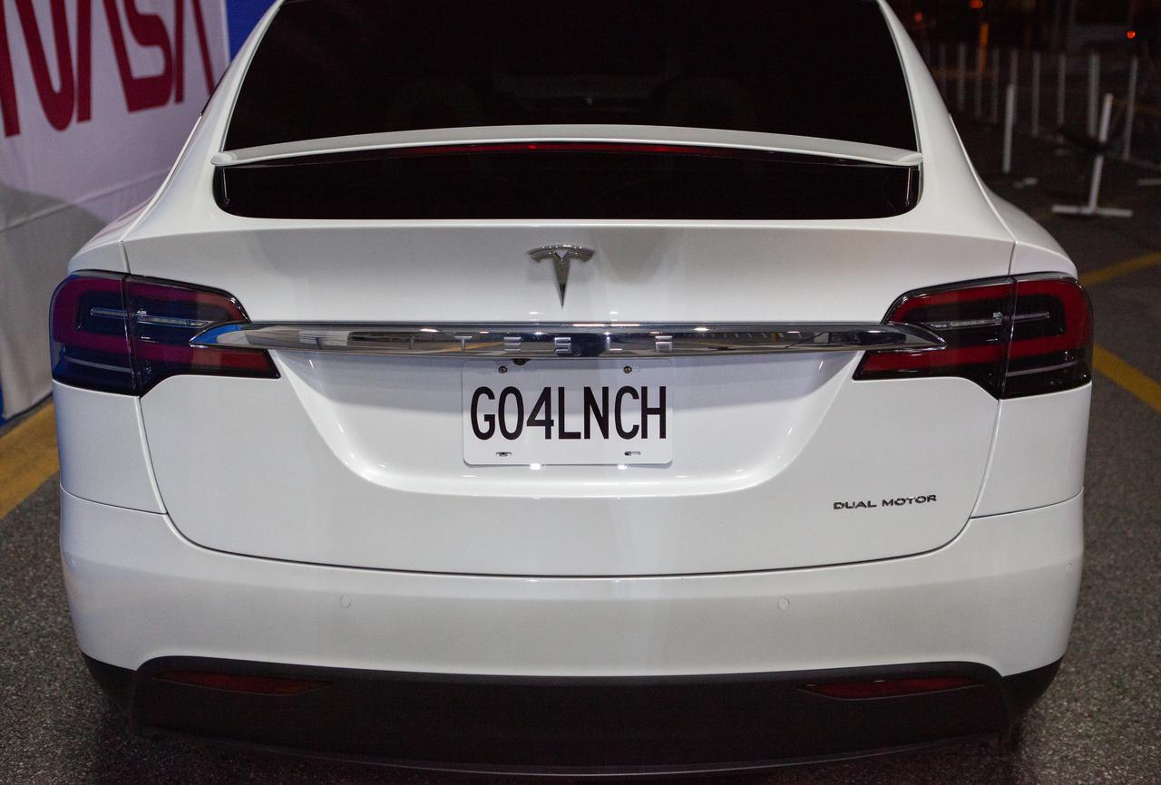 A customized Tesla Model X vehicle is parked outside the Neil A. Armstrong Operations and Checkout Building at NASA’s Kennedy Space Center in Florida on April 27, 2022. Crew-4 astronauts Kjell Lindgren, Bob Hines, Jessica Watkins, and Samantha Cristoforetti will make their way to the vehicles, which will transport them to Launch Complex 39A. Liftoff aboard SpaceX’s Crew Dragon, powered by the company’s Falcon 9 rocket, is scheduled for today at 3:52 a.m. EDT from Pad 39A at Kennedy.