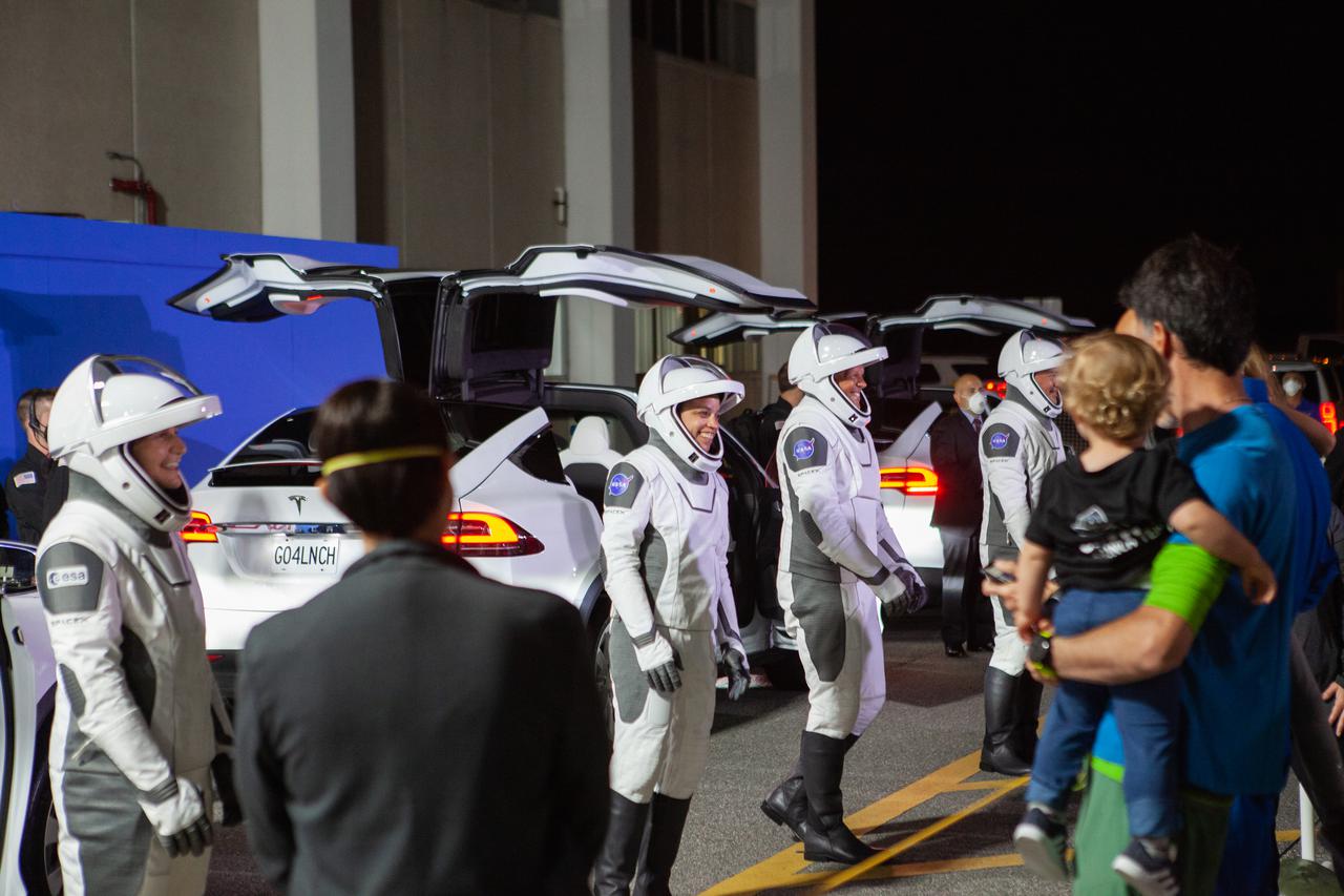 Crew-4 astronauts Kjell Lindgren, Samantha Cristoforetti, Bob Hines, and Jessica Watkins wave to their families outside of the Neil Armstrong Operations and Checkout Building at NASA’s Kennedy Space Center in Florida before getting into the customized Tesla Model X vehicles that will transport them to their spacecraft at Launch Complex 39A. SpaceX’s Crew Dragon, powered by the company’s Falcon 9 rocket, will carry the four-person crew to the International Space Station as part of NASA’s Commercial Crew Program. Crew-4 is scheduled to launch today at 3:52 a.m. EDT, from Pad 39A at Kennedy.