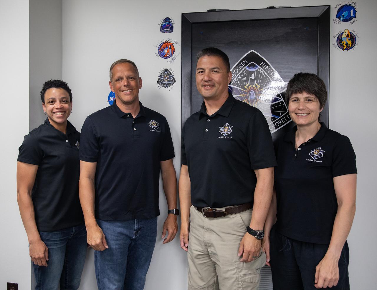 From left, Crew-4 mission astronauts Jessica Watkins, Bob Hines, Kjell Lindgren, and Samantha Cristoforetti, pose in the Astronaut Crew Quarters inside Kennedy Space Center’s Neil A. Armstrong Operations and Checkout Building on April 27, 2022. The four astronauts will launch aboard SpaceX’s Crew Dragon – powered by the company’s Falcon 9 rocket – to the International Space Station as part of NASA’s Commercial Crew Program. They are scheduled to lift off today at 3:52 a.m. EDT from Launch Complex 39A at Kennedy.