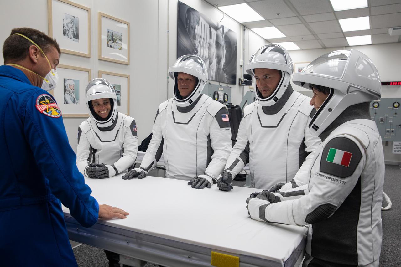 Crew-4 mission astronauts, from left, Jessica Watkins, Bob Hines, Kjell Lindgren, and Samantha Cristoforetti relax in the suit room in the Astronaut Crew Quarters inside Kennedy Space Center’s Neil A. Armstrong Operations and Checkout Building on April 27, 2022. A team of SpaceX suit technicians assisted the crew as they put on their custom-fitted spacesuits and checked the suits for leaks. The astronauts will launch aboard SpaceX’s Crew Dragon, powered by the company’s Falcon 9 rocket, to the International Space Station as part of NASA’s Commercial Crew Program. Crew-4 is scheduled to lift off today at 3:52 a.m. EDT from Launch Complex 39A at Kennedy.