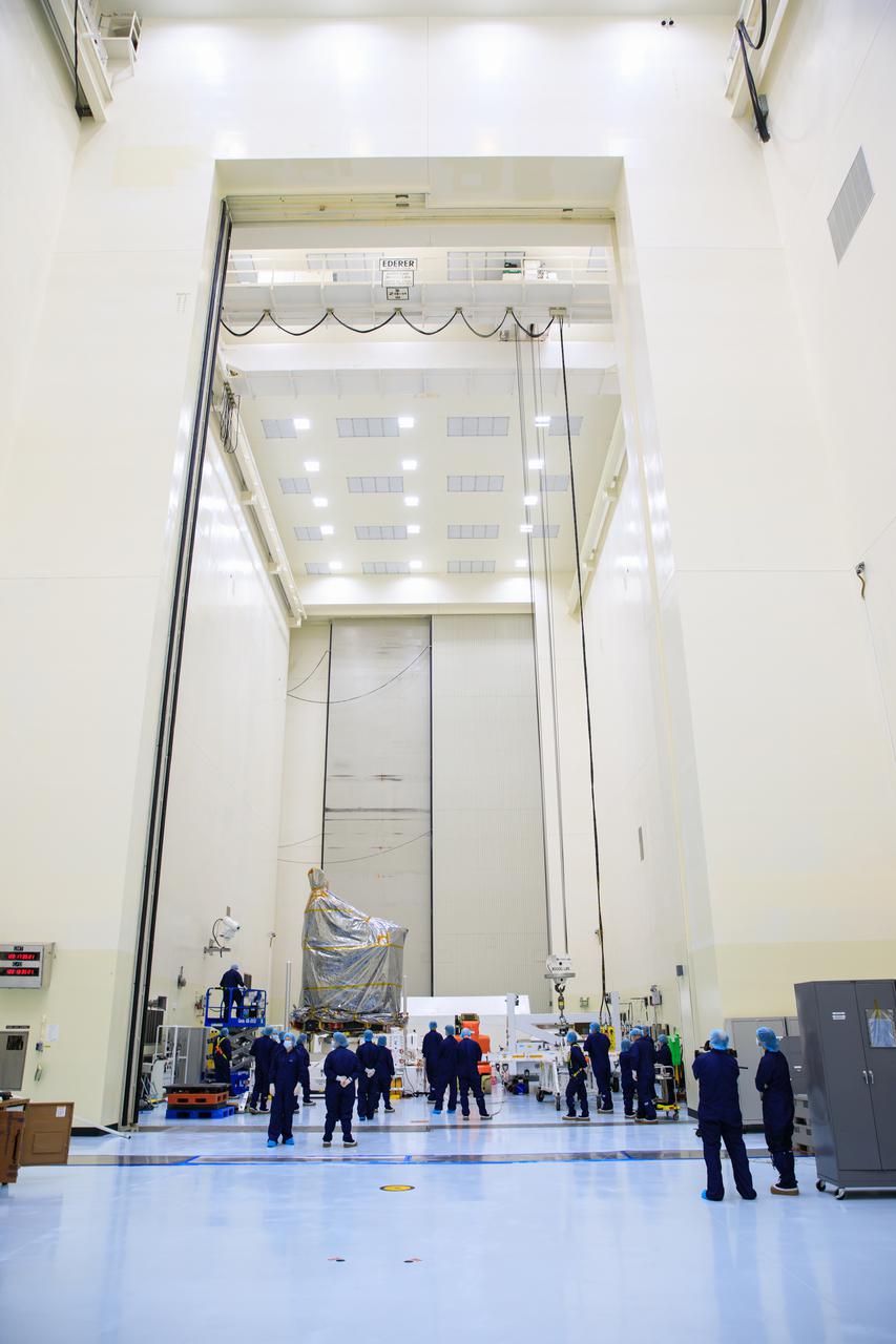 Inside the Payload Hazardous Servicing Facility (PHSF) at NASA's Kennedy Space Center, technicians prepare to move the agency’s Psyche spacecraft – recently removed from its shipping container and inside a protective covering – to a work stand on May 2, 2022. Psyche is scheduled to launch aboard a SpaceX Falcon Heavy rocket on Aug. 1, 2022. The spacecraft will use solar-electric propulsion to travel approximately 1.5 billion miles to rendezvous with its namesake asteroid in 2026. The Psyche mission is led by Arizona State University. NASA’s Jet Propulsion Laboratory, which is managed for the agency by Caltech in Pasadena, California, is responsible for the mission’s overall management, system engineering, integration and testing, and mission operations. Maxar Technologies in Palo Alto, California, provided the high-power solar electric propulsion spacecraft chassis. NASA’s Launch Services Program (LSP), based at Kennedy, is managing the launch. Psyche will be the 14th mission in the agency's Discovery program and LSP’s 100th primary mission. 
