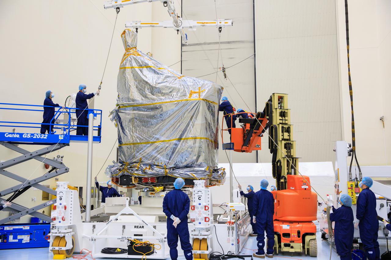 Inside the Payload Hazardous Servicing Facility (PHSF) at NASA's Kennedy Space Center, the agency’s Psyche spacecraft – recently removed from its shipping container and inside a protective covering – is moved by crane to a work stand on Monday, May 2, 2022. Psyche is scheduled to launch aboard a SpaceX Falcon Heavy rocket on Aug. 1, 2022. The spacecraft will use solar-electric propulsion to travel approximately 1.5 billion miles to rendezvous with its namesake asteroid in 2026. The Psyche mission is led by Arizona State University. NASA’s Jet Propulsion Laboratory, which is managed for the agency by Caltech in Pasadena, California, is responsible for the mission’s overall management, system engineering, integration and testing, and mission operations. Maxar Technologies in Palo Alto, California, provided the high-power solar electric propulsion spacecraft chassis. NASA’s Launch Services Program (LSP), based at Kennedy, is managing the launch. Psyche will be the 14th mission in the agency's Discovery program and LSP’s 100th primary mission. 