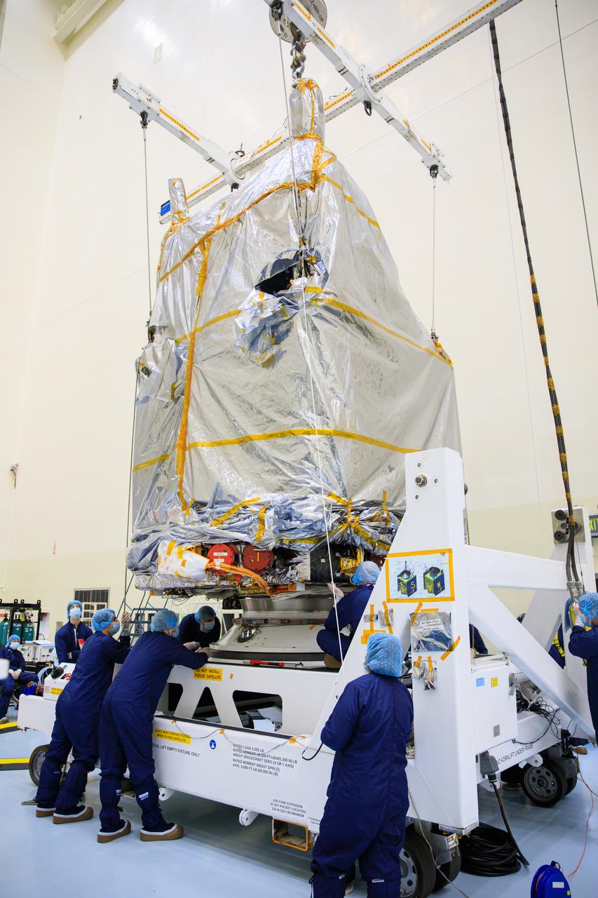 Inside the Payload Hazardous Servicing Facility (PHSF) at NASA's Kennedy Space Center, the agency’s Psyche spacecraft – recently removed from its shipping container and inside a protective covering – is moved by crane to a work stand on Monday, May 2, 2022. Psyche is scheduled to launch aboard a SpaceX Falcon Heavy rocket on Aug. 1, 2022. The spacecraft will use solar-electric propulsion to travel approximately 1.5 billion miles to rendezvous with its namesake asteroid in 2026. The Psyche mission is led by Arizona State University. NASA’s Jet Propulsion Laboratory, which is managed for the agency by Caltech in Pasadena, California, is responsible for the mission’s overall management, system engineering, integration and testing, and mission operations. Maxar Technologies in Palo Alto, California, provided the high-power solar electric propulsion spacecraft chassis. NASA’s Launch Services Program (LSP), based at Kennedy, is managing the launch. Psyche will be the 14th mission in the agency's Discovery program and LSP’s 100th primary mission. 