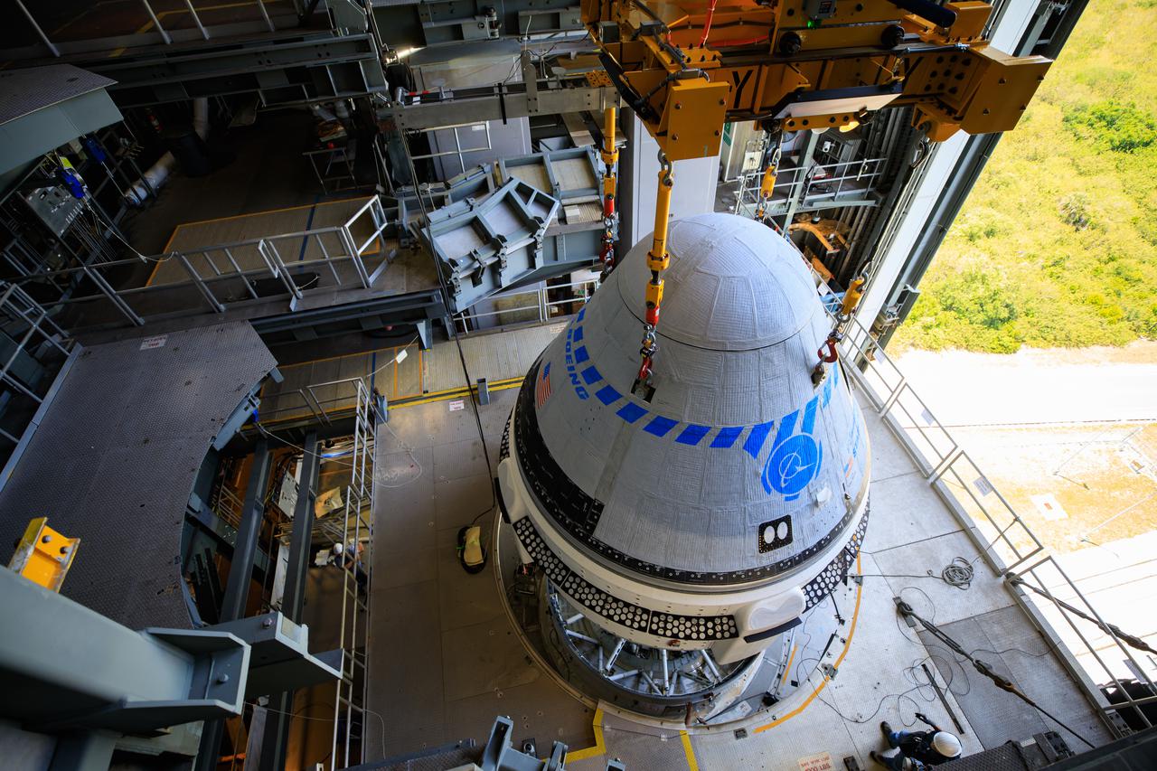 The Boeing CST-100 Starliner spacecraft is lifted at the Vertical Integration Facility at Space Launch Complex-41 at Florida's Cape Canaveral Space Force Station on May 4th, 2022. Starliner will be secured atop a United Launch Alliance Atlas V rocket for Boeing's second Orbital Flight Test (OFT-2) to the International Space Station for NASA's Commercial Crew Program. The spacecraft rolled out from Boeing's Commercial Crew and Cargo Processing Facility at NASA's Kennedy Space Center earlier in the day.