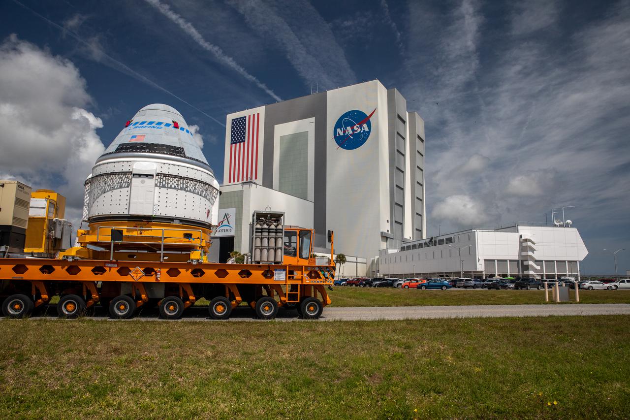 Boeing’s CST-100 Starliner spacecraft passes by the iconic Vehicle Assembly Building at NASA’s Kennedy Space Center in Florida on May 4, 2022, making its way to the Space Launch Complex-41 Vertical Integration Facility at Cape Canaveral Space Force Station. At the pad, Starliner will be secured atop a United Launch Alliance Atlas V rocket in preparation for Boeing’s second Orbital Flight Test (OFT-2) to the International Space Station for NASA’s Commercial Crew Program.
