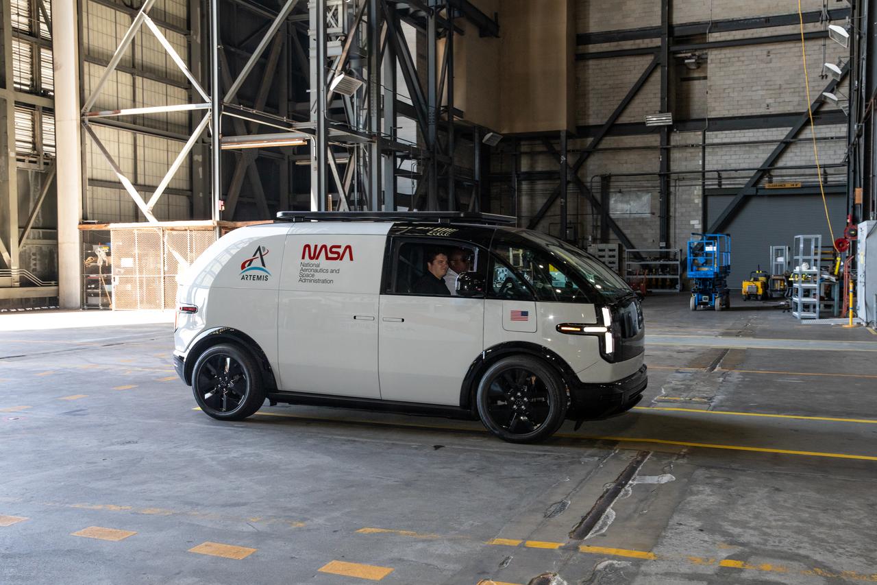 A concept design of a crew transportation vehicle (CTV) for Artemis crewed missions is driven inside the transfer aisle of the Vehicle Assembly Building at NASA’s Kennedy Space Center in Florida on May 11, 2022. Canoo Technologies Inc., was awarded a contract to design and provide the next generation of CTVs for the Artemis crewed missions. Representatives with Canoo  were at the spaceport demonstrating the environmentally friendly fleet of vehicles. Artemis II will be the first Artemis mission flying crew aboard Orion. In later missions, NASA will land the first woman and the first person of color on the surface of the Moon, paving the way for a long-term lunar presence and serving as a steppingstone on the way to Mars. 