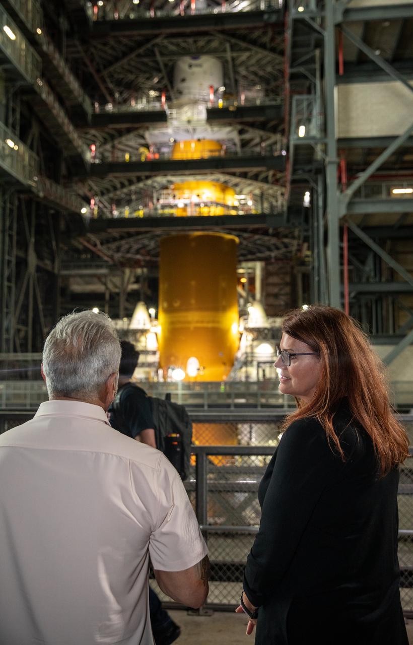 Artemis I Launch Director Charlie Blackwell Thompson, at right, views the Artemis I Space Launch System and Orion stack with Anthony Aquila, chief executive officer of Canoo Technologies Inc., inside High Bay 3 of the Vehicle Assembly Building at NASA’s Kennedy Space Center in Florida on May 11, 2022. Canoo Technologies, was awarded a contract to design and provide the next generation of CTVs for the Artemis crewed missions. Representatives with Canoo were at the spaceport demonstrating the environmentally friendly fleet of vehicles. Artemis II will be the first Artemis mission flying crew aboard Orion. In later missions, NASA will land the first woman and the first person of color on the surface of the Moon, paving the way for a long-term lunar presence and serving as a steppingstone on the way to Mars. 