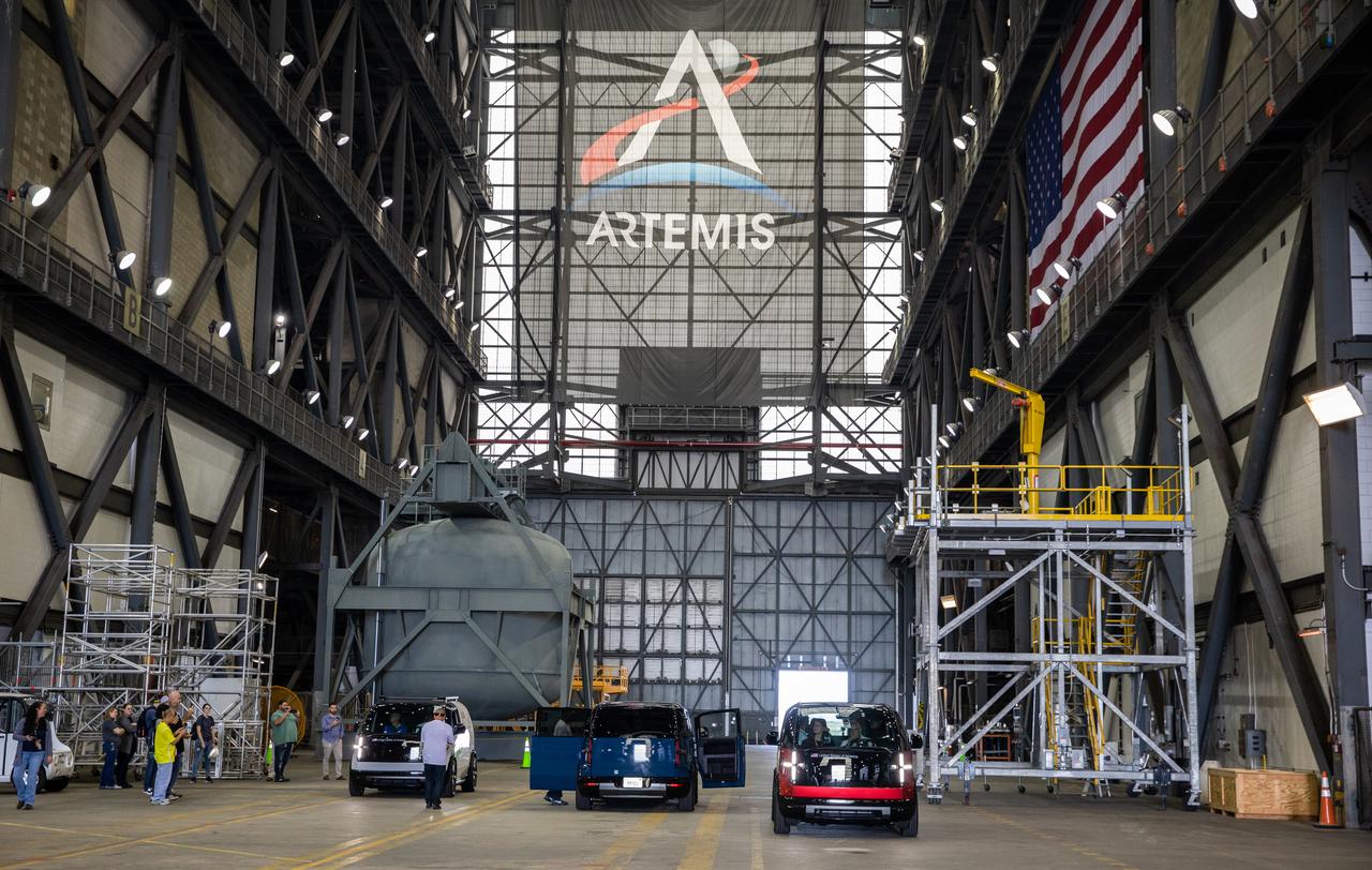 Several concept designs for Artemis crew transportation vehicles (CTV) are lined up in the transfer aisle of the Vehicle Assembly Building at NASA’s Kennedy Space Center in Florida on May 11, 2022. Canoo Technologies Inc., was awarded a contract to design and provide the next generation of CTVs for the Artemis crewed missions. Representatives with Canoo were at the spaceport demonstrating the environmentally friendly fleet of vehicles. Artemis II will be the first Artemis mission flying crew aboard Orion. In later missions, NASA will land the first woman and the first person of color on the surface of the Moon, paving the way for a long-term lunar presence and serving as a steppingstone on the way to Mars. 