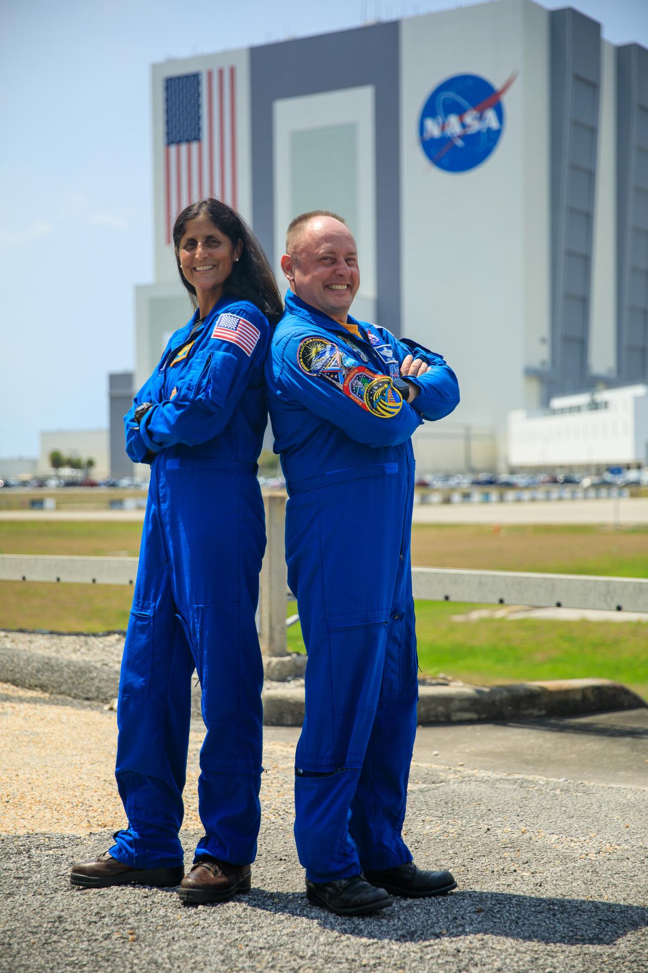 NASA astronauts Suni Williams and Mike Fincke are photographed in front of the Vehicle Assembly Building at Kennedy Space Center.
