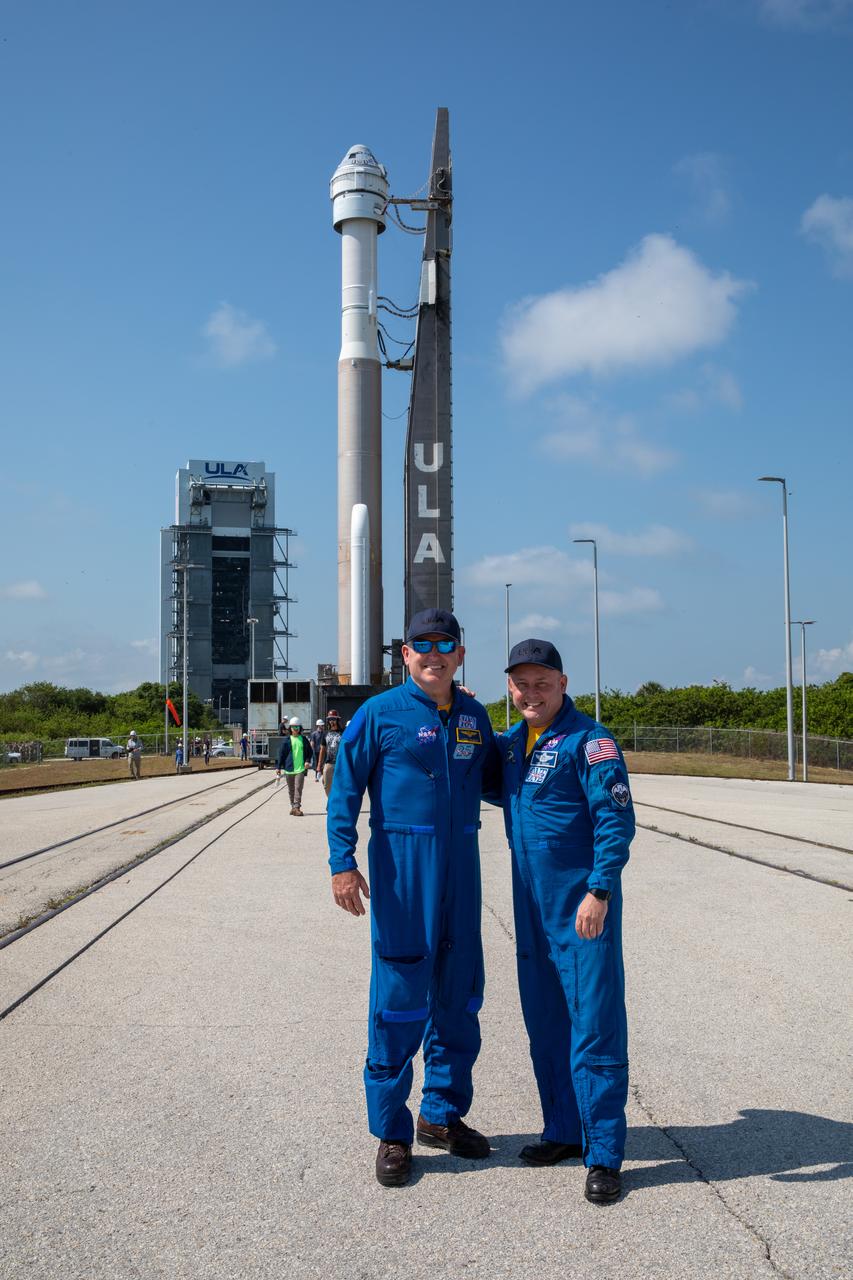 NASA astronauts Butch Wilmore, left, and Mike Fincke, right, watch as a United Launch Alliance Atlas V rocket with Boeing’s CST-100 Starliner spacecraft aboard is rolled out of the Vertical Integration Facility to the launch pad at Space Launch Complex 41 ahead of the Orbital Flight Test-2 (OFT-2), Wednesday, May 18, 2022 at Cape Canaveral Space Force Station in Florida. Starliner is targeted to launch at 6:54 p.m. EDT on Thursday, May 19. OFT-2 is an important uncrewed flight test designed to test the end-to-end capabilities of the system to help the agency certify Starliner to carry astronauts to and from the International Space Station.