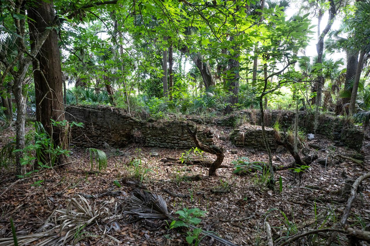 Archeological ruins of the Elliot Plantation sugar mill are revealed through the oak hammock at NASA’s Kennedy Space Center in Florida on May 26, 2022. The plantation’s enslaved community built the sugar mill structure, or sugar train, where sugar cane juice would be boiled during processing in graduated copper kettles until the liquid reduced into a thick syrup. The ruins of Elliot Plantation date from the 1760s and represent the largest, earliest, and southernmost British period sugar plantation in the U.S., as well as one of the most intact and best examples of a completely preserved enslaved landscape. The archeological site is managed through interagency cooperation between the National Park Service, the U.S. Fish and Wildlife Service, and NASA.