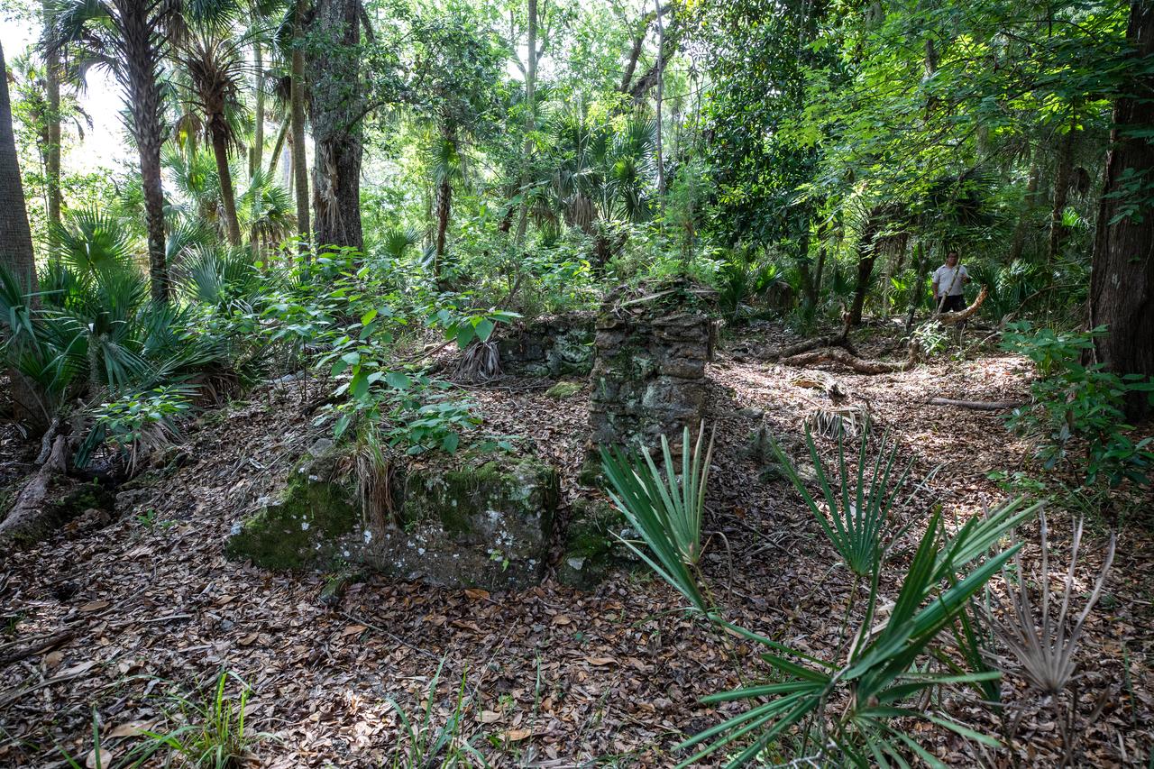 Archeological ruins of the Elliot Plantation sugar mill are revealed through the oak hammock at NASA’s Kennedy Space Center in Florida on May 26, 2022. The plantation’s enslaved community built the sugar mill structure, or sugar train, where sugar cane juice would be boiled during processing in graduated copper kettles until the liquid reduced into a thick syrup. The ruins of Elliot Plantation date from the 1760s and represent the largest, earliest, and southernmost British period sugar plantation in the U.S., as well as one of the most intact and best examples of a completely preserved enslaved landscape. The archeological site is managed through interagency cooperation between the National Park Service, the U.S. Fish and Wildlife Service, and NASA.