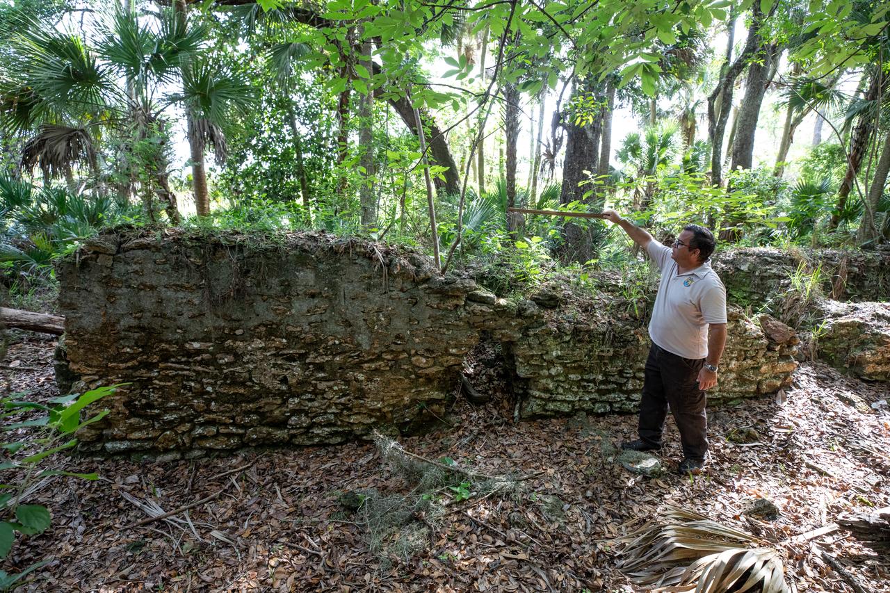 Near the archeological ruins of the Elliot Plantation sugar mill at NASA’s Kennedy Space Center in Florida, Michael Legare, of the U.S. Fish and Wildlife Service, recreates the original wall height of the structure on May 26, 2022. The plantation’s enslaved community built the sugar mill structure, or sugar train, where sugar cane juice would be boiled during processing in graduated copper kettles until the liquid reduced into a thick syrup. The ruins of Elliot Plantation date from the 1760s and represent the largest, earliest, and southernmost British period sugar plantation in the U.S., as well as one of the most intact and best examples of a completely preserved enslaved landscape. The archeological site is managed through interagency cooperation between the National Park Service, the U.S. Fish and Wildlife Service, and NASA.