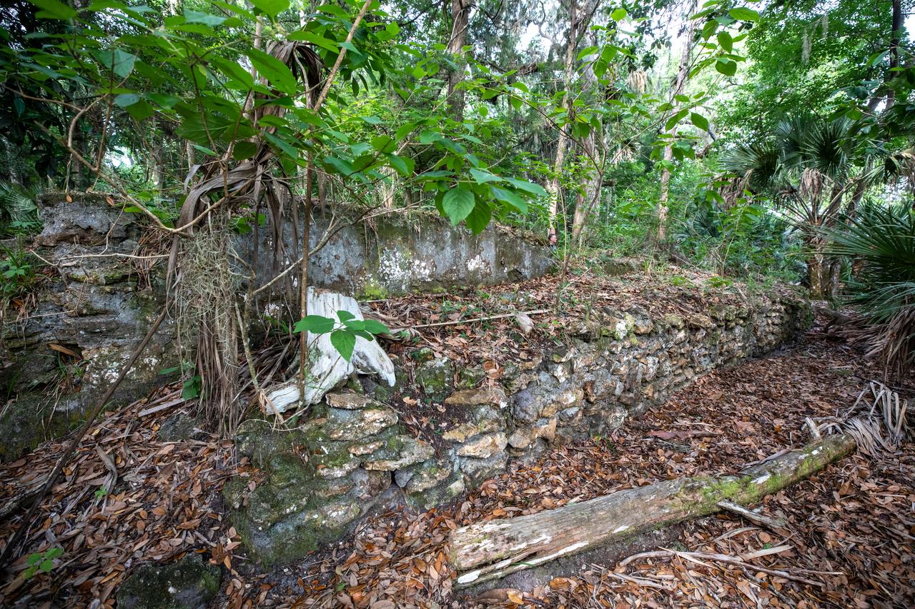 Archeological ruins of the Elliot Plantation sugar mill are revealed through the oak hammock at NASA’s Kennedy Space Center in Florida on May 26, 2022. The plantation’s enslaved community built the sugar mill structure, or sugar train, where sugar cane juice would be boiled during processing in graduated copper kettles until the liquid reduced into a thick syrup. The ruins of Elliot Plantation date from the 1760s and represent the largest, earliest, and southernmost British period sugar plantation in the U.S., as well as one of the most intact and best examples of a completely preserved enslaved landscape. The archeological site is managed through interagency cooperation between the National Park Service, the U.S. Fish and Wildlife Service, and NASA.