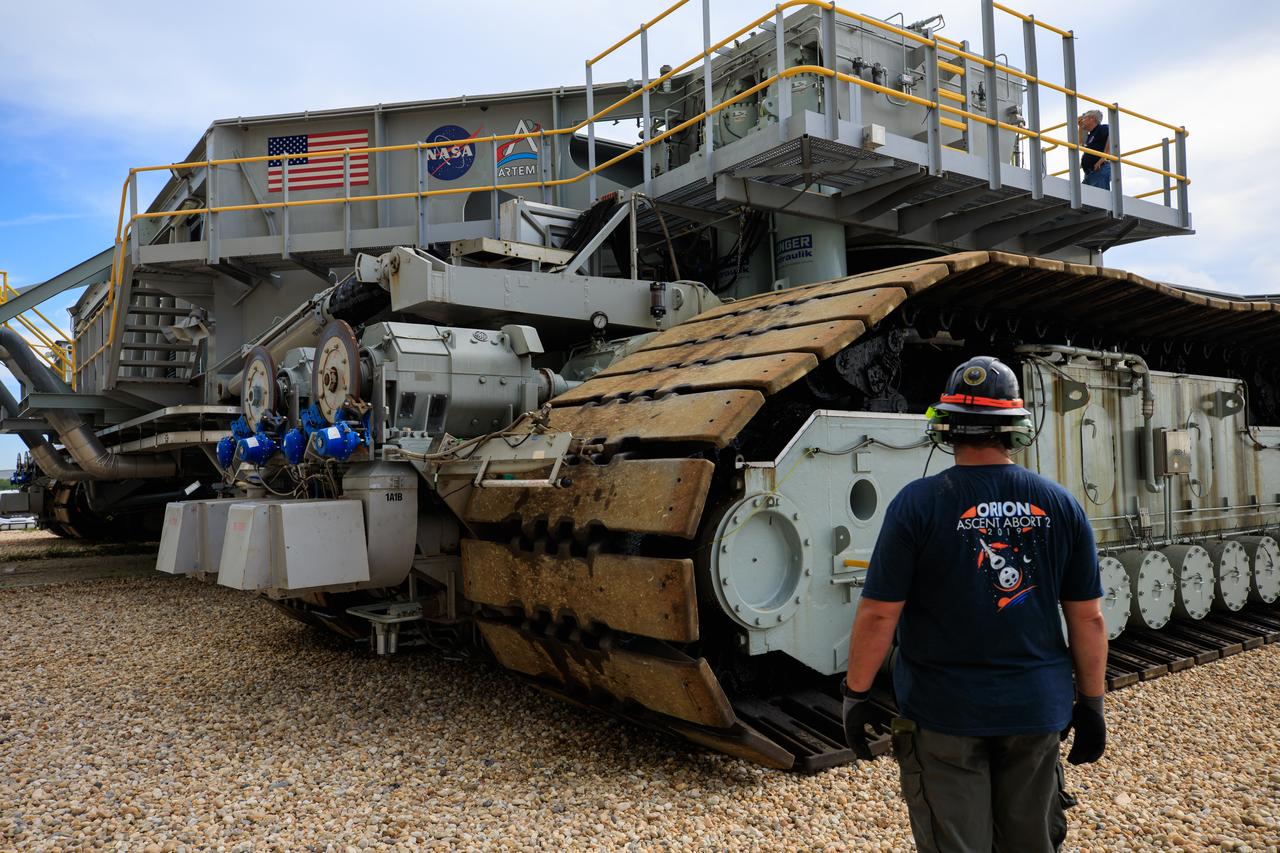 A technician checks the giant tracks crawler-transporter 2 during its trip to the Vehicle Assembly Building (VAB) at NASA’s Kennedy Space Center in Florida on June 3, 2022. The crawler will go inside the VAB, where it will slide under the Artemis I Space Launch System with the Orion spacecraft atop on the mobile launcher and carry it to Launch Complex 39B for a wet dress rehearsal test ahead of the Artemis I launch. Artemis I will be the first integrated test of the SLS and Orion spacecraft. In later missions, NASA will land the first woman and the first person of color on the surface of the Moon, paving the way for a long-term lunar presence and serving as a steppingstone on the way to Mars. 