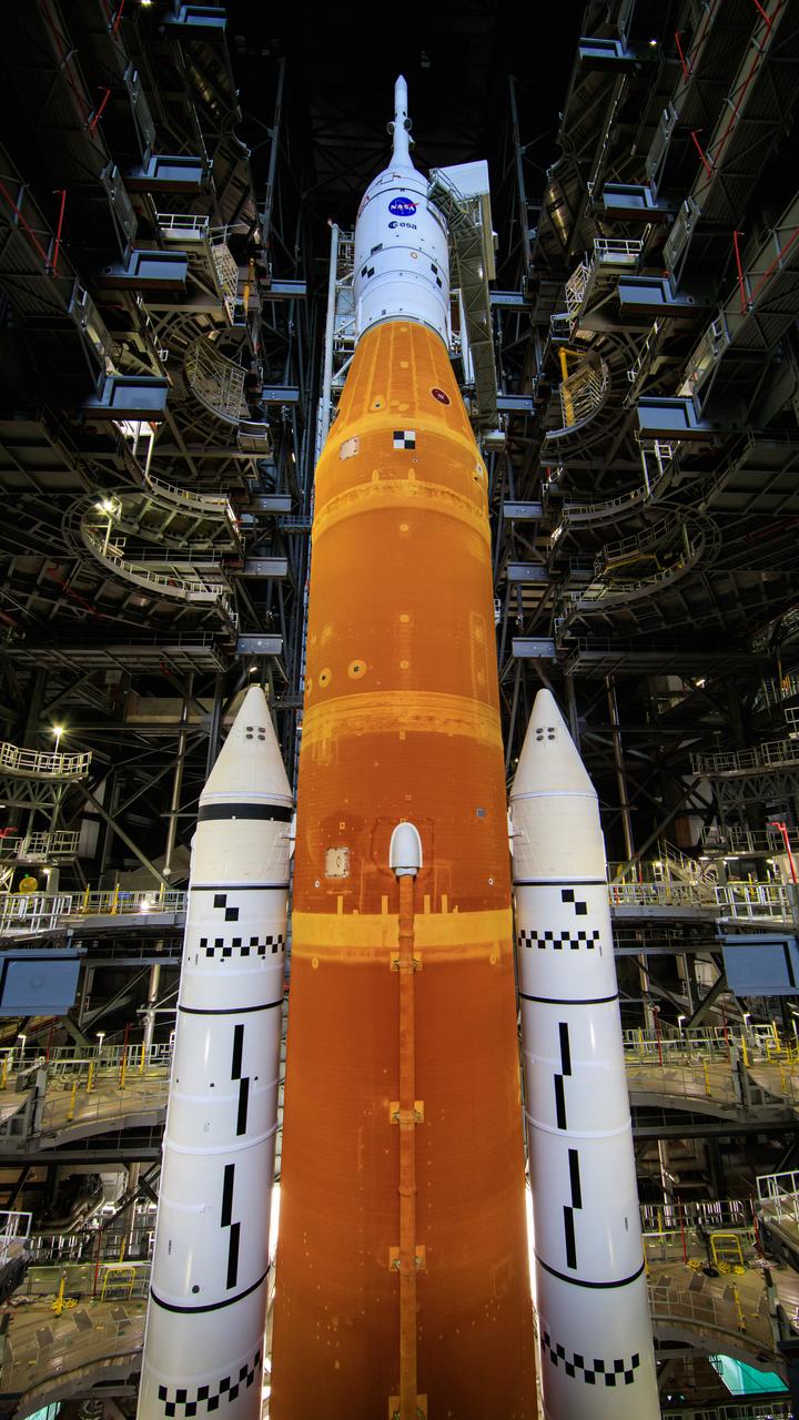NASA’s Space Launch System and Orion spacecraft atop the mobile launcher are in view in High Bay 3 of the Vehicle Assembly Building at the agency’s Kennedy Space Center in Florida on June 3, 2022. All of the work platforms have been retracted. The crawler-transporter, driven by engineers, is under the Artemis I stack atop the mobile launcher and will carry it to Launch Complex 39B for a wet dress rehearsal test ahead of the Artemis I launch. Artemis I will be the first integrated test of the SLS and Orion spacecraft. In later missions, NASA will land the first woman and the first person of color on the surface of the Moon, paving the way for a long-term lunar presence and serving as a steppingstone on the way to Mars.