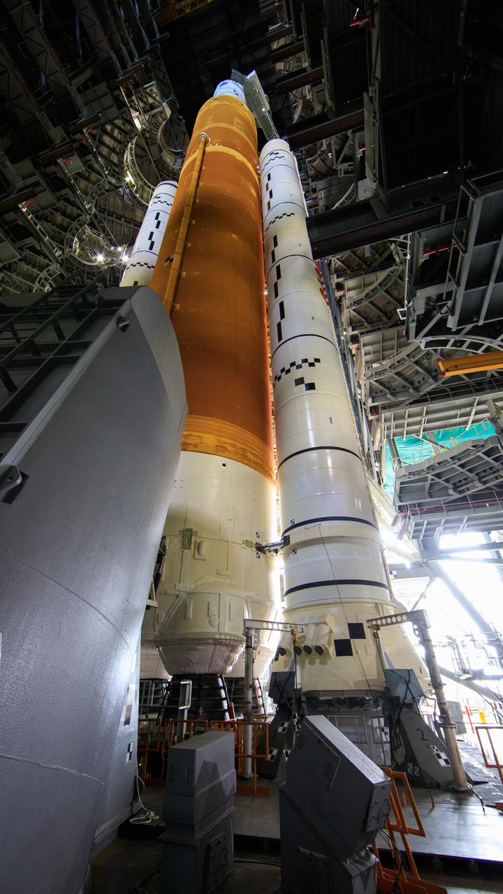 NASA’s Space Launch System and Orion spacecraft atop the mobile launcher are in view in High Bay 3 of the Vehicle Assembly Building at the agency’s Kennedy Space Center in Florida on June 3, 2022. All of the work platforms have been retracted. The crawler-transporter, driven by engineers, is under the Artemis I stack atop the mobile launcher and will carry it to Launch Complex 39B for a wet dress rehearsal test ahead of the Artemis I launch. Artemis I will be the first integrated test of the SLS and Orion spacecraft. In later missions, NASA will land the first woman and the first person of color on the surface of the Moon, paving the way for a long-term lunar presence and serving as a steppingstone on the way to Mars.