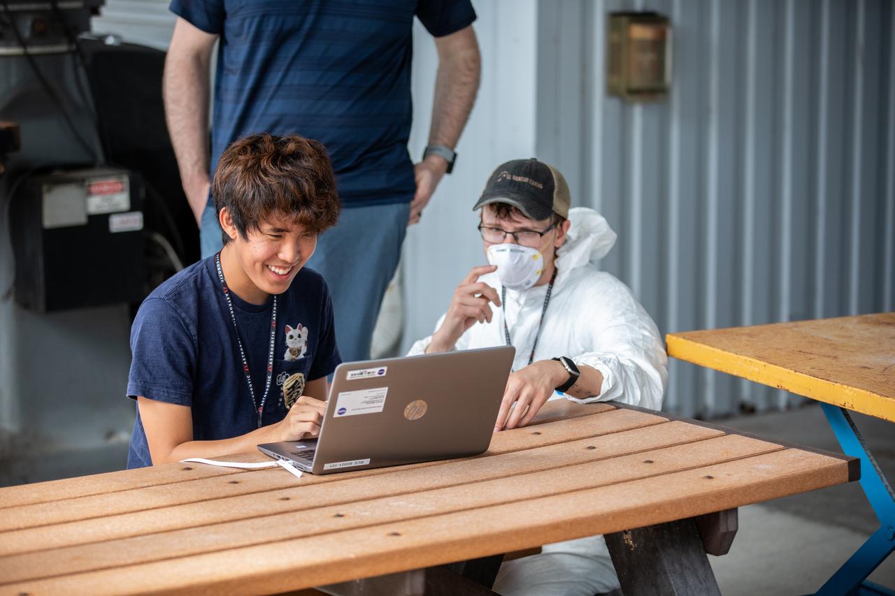 Senior Software Engineer Taylor Whitaker (right) and Software Engineering intern Ashten Akemoto create a mobility routine for Astrobotic’s CubeRover – a lightweight, modular planetary rover – using the company’s ground software at NASA’s Kennedy Space Center in Florida on June 30, 2022. Astrobotic – a Pittsburgh-based space robotics company – is using the spaceport’s Swamp Works facility and the Granular Mechanics and Regolith Operations Laboratory to conduct mobility testing of their rover. The laboratory’s regolith bin, which holds approximately 120 tons of lunar regolith simulant, will help depict how the company’s CubeRover would perform on the Moon. NASA’s Small Business Innovation Research program provided the funding for initial development, and a $2 million Tipping Point award from the agency has provided additional funding for continued development into a more mature rover.