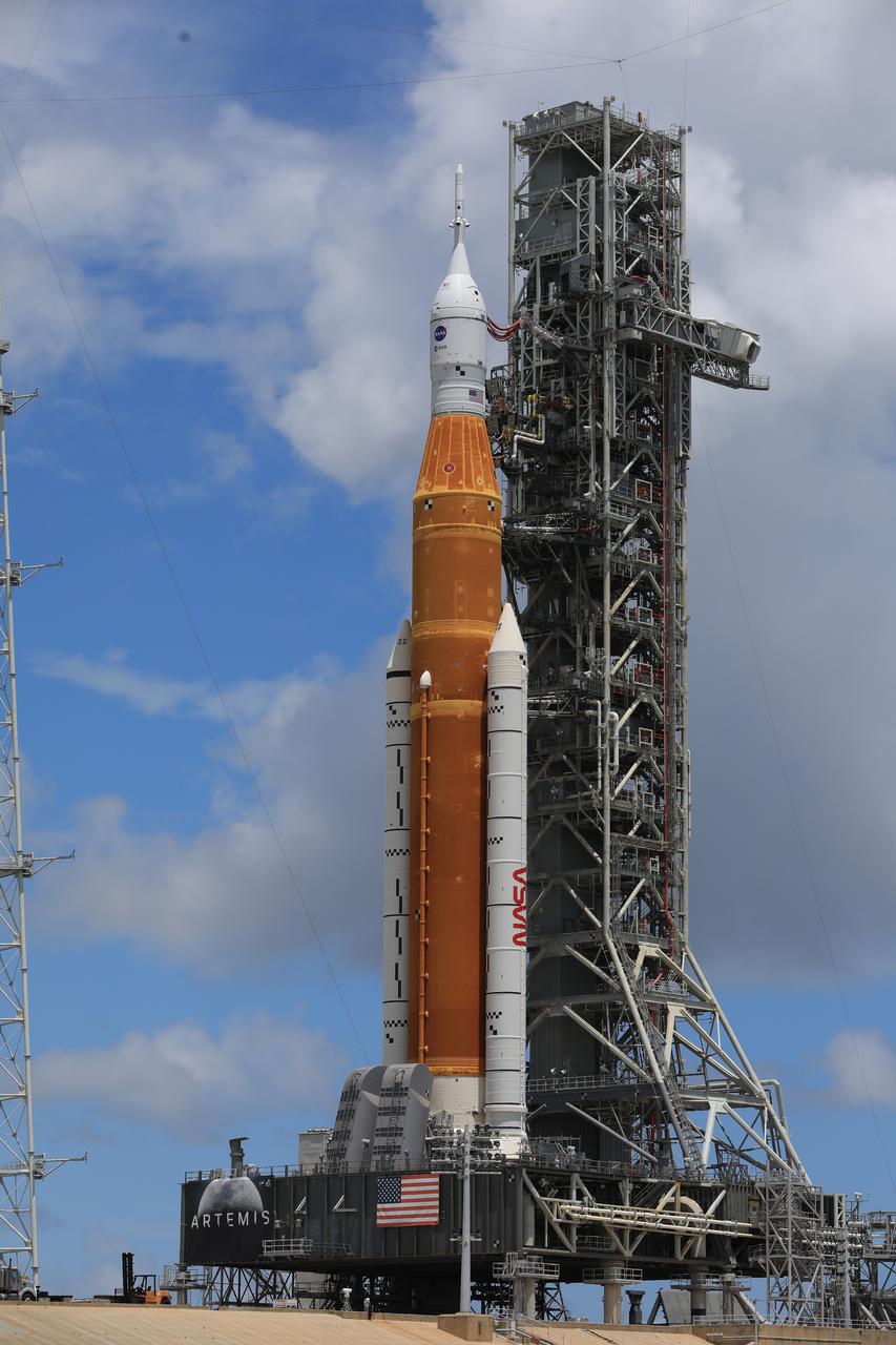 A view of the Artemis I Space Launch System (SLS) and Orion spacecraft atop the mobile launcher at Launch Pad 39B at NASA’s Kennedy Space Center in Florida on June 30, 2022. The SLS and Orion were transported to the pad on crawler-transporter 2 for a prelaunch test called a wet dress rehearsal. Artemis I will be the first integrated test of the SLS and Orion spacecraft. In later missions, NASA will land the first woman and the first person of color on the surface of the Moon, paving the way for a long-term lunar presence and serving as a steppingstone on the way to Mars. 