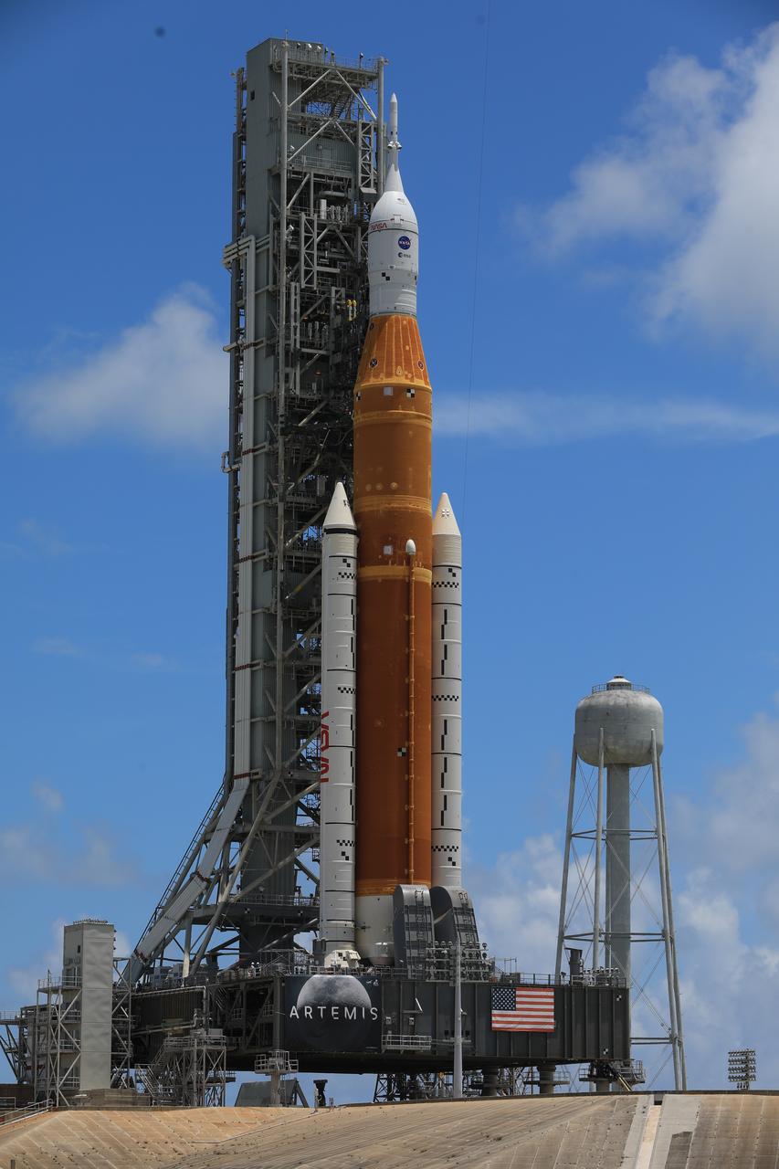 A close-up view of the Artemis I Space Launch System (SLS) and Orion spacecraft atop the mobile launcher at Launch Pad 39B at NASA’s Kennedy Space Center in Florida on June 30, 2022. The SLS and Orion were transported to the pad on crawler-transporter 2 for a prelaunch test called a wet dress rehearsal. Artemis I will be the first integrated test of the SLS and Orion spacecraft. In later missions, NASA will land the first woman and the first person of color on the surface of the Moon, paving the way for a long-term lunar presence and serving as a steppingstone on the way to Mars. 