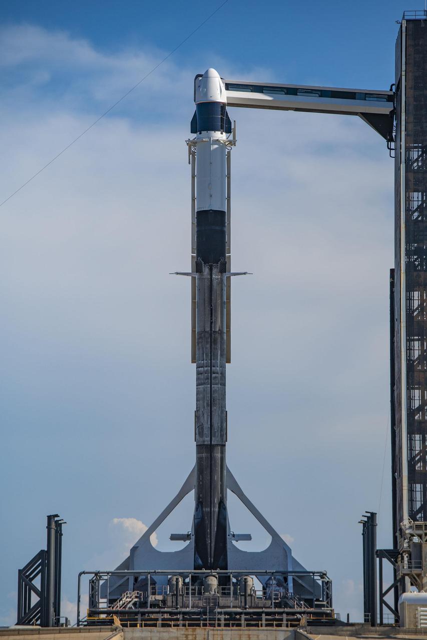 A SpaceX Falcon 9 rocket, with the company’s Cargo Dragon spacecraft atop, is raised to a vertical position at NASA Kennedy Space Center’s Launch Complex 39A on July 12, 2022, in preparation for the 25th commercial resupply services launch to the International Space Station. The mission will deliver new science investigations, supplies, and equipment to the crew aboard the orbiting laboratory. Liftoff is scheduled for 8:44 p.m. EDT on Thursday, July 14, from Kennedy’s Launch Complex 39A. 