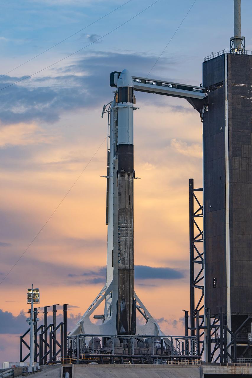 A SpaceX Falcon 9 rocket, with the company’s Cargo Dragon spacecraft atop, is raised to a vertical position at NASA Kennedy Space Center’s Launch Complex 39A on July 12, 2022, in preparation for the 25th commercial resupply services launch to the International Space Station. The mission will deliver new science investigations, supplies, and equipment to the crew aboard the orbiting laboratory. Liftoff is scheduled for 8:44 p.m. EDT on Thursday, July 14, from Kennedy’s Launch Complex 39A.
