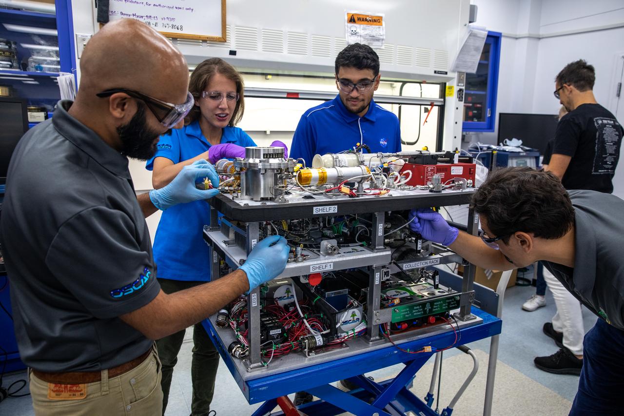 The Trash to Gas team members prepare flight hardware for NASA’s Orbital Syngas Commodity Augmentation Reactor, or OSCAR, inside the Applied Physics Lab in the Neil Armstrong Operations and Checkout Facility at the agency’s Kennedy Space Center in Florida on July 21, 2022. OSCAR began as an Early Career Initiative project at the spaceport that studies technology to convert trash and human waste into useful gasses such as methane, hydrogen, and carbon dioxide. By processing small pieces of trash in a high-temperature reactor, OSCAR is advancing new and innovative technology for managing waste in space. 