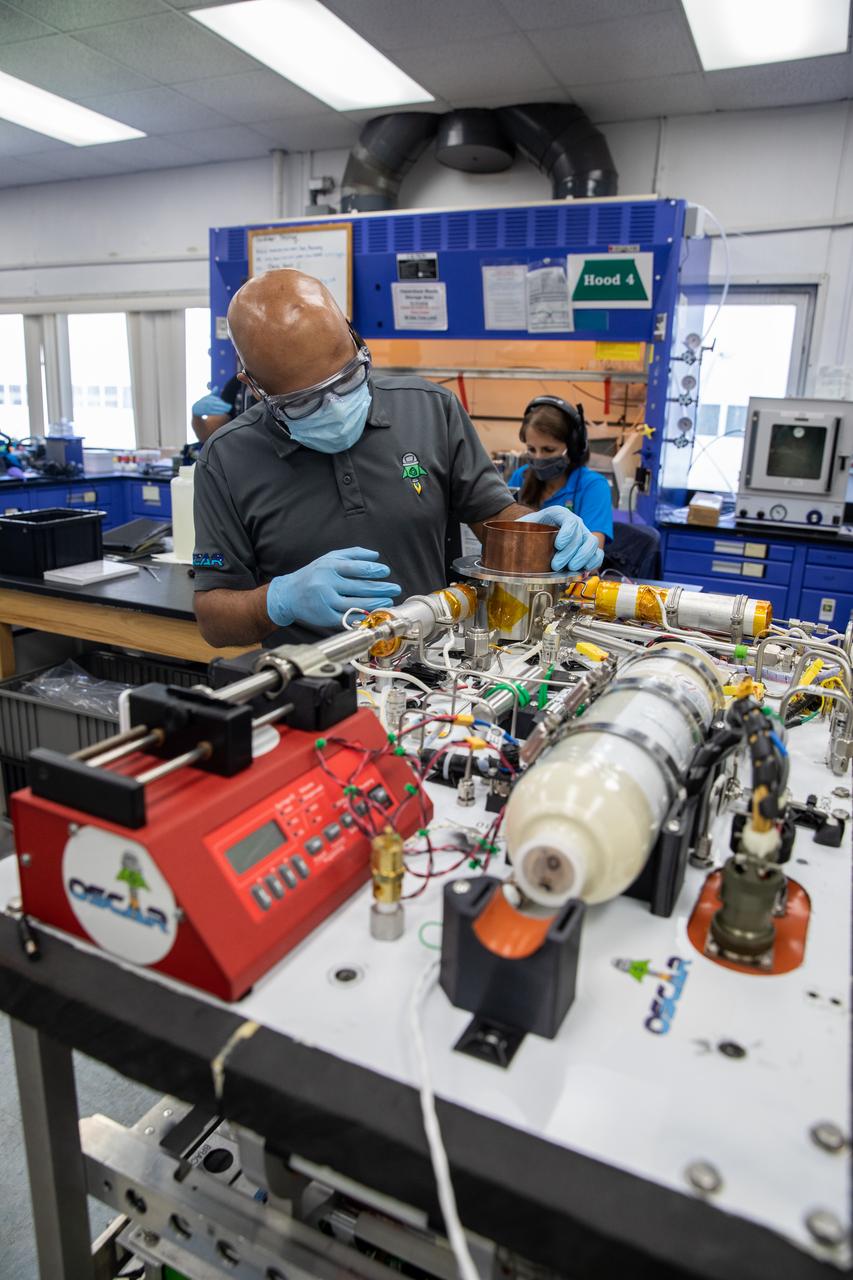 A Trash to Gas team member prepares flight hardware for NASA’s Orbital Syngas Commodity Augmentation Reactor, or OSCAR, inside the Applied Physics Lab in the Neil Armstrong Operations and Checkout Facility at the agency’s Kennedy Space Center in Florida on July 21, 2022. OSCAR began as an Early Career Initiative project at the spaceport that studies technology to convert trash and human waste into useful gasses such as methane, hydrogen, and carbon dioxide. By processing small pieces of trash in a high-temperature reactor, OSCAR is advancing new and innovative technology for managing waste in space.