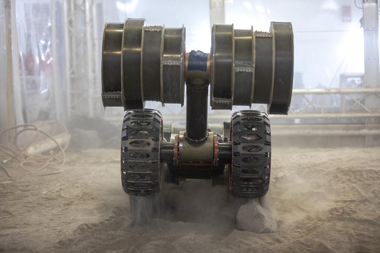 The ISRU Pilot Excavator is tested in the regolith bin inside Swamp Works at NASA’s Kennedy Space Center in Florida on July 28, 2022. Tests use a gravity assist offload system to simulate reduced gravity conditions found on the Moon. On the surface of the Moon, mining robots like the Pilot Excavator will excavate the regolith and take the material to a processing plant where usable elements such as hydrogen, oxygen and water can be extracted for life support systems. The Pilot Excavator can scoop up icy regolith which can be used to make operations on the Moon sustainable.
