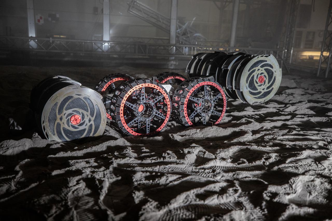 With the lights out, the ISRU Pilot Excavator digs in the regolith bin during testing inside Swamp Works at NASA’s Kennedy Space Center in Florida on July 28, 2022. Tests use a gravity assist offload system to simulate reduced gravity conditions found on the Moon. On the surface of the Moon, mining robots like the Pilot Excavator will excavate the regolith and take the material to a processing plant where usable elements such as hydrogen, oxygen and water can be extracted for life support systems. The Pilot Excavator can scoop up icy regolith which can be used to make operations on the Moon sustainable.