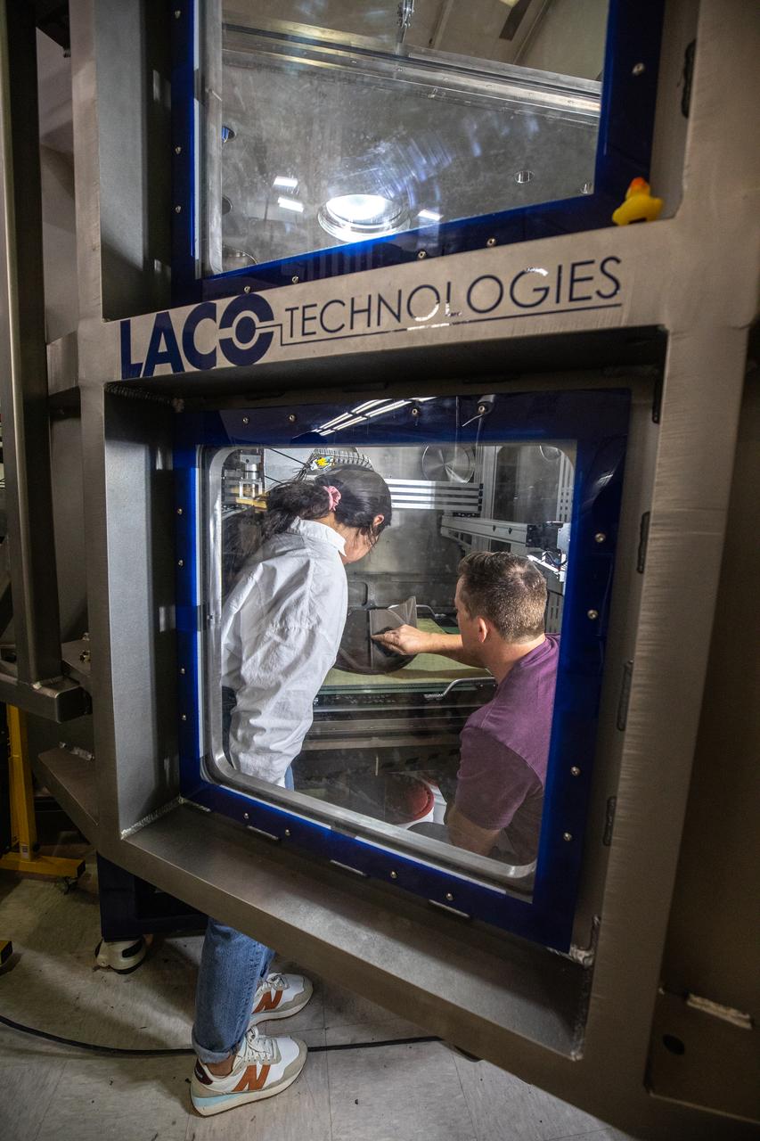 Chemist Nilab Azim, left, and Nathan Gelino, principal investigator with NASA’s Exploration Research and Technology programs, test a 3D printer on July 28, 2022, at Swamp Works at the agency’s Kennedy Space Center in Florida, as part of the Relevant Environment Additive Construction Technology (REACT) project. Among the key objectives of the project is developing an architectural and structural design for a shelter that provides protection to habitable assets on the lunar surface. Testing REACT derives from NASA’s 2020 Announcement of Collaboration Opportunity with AI SpaceFactory – an architectural and construction technology company and winner of NASA’s 3D Printed Habitat Challenge.