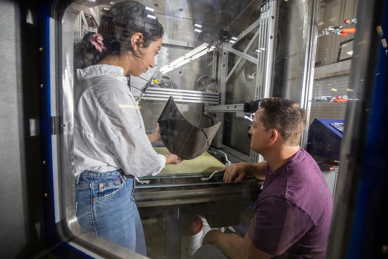 Chemist Nilab Azim, left, and Nathan Gelino, principal investigator with NASA’s Exploration Research and Technology programs, test a 3D printer on July 28, 2022, at Swamp Works at the agency’s Kennedy Space Center in Florida, as part of the Relevant Environment Additive Construction Technology (REACT) project. Among the key objectives of the project is developing an architectural and structural design for a shelter that provides protection to habitable assets on the lunar surface. Testing REACT derives from NASA’s 2020 Announcement of Collaboration Opportunity with AI SpaceFactory – an architectural and construction technology company and winner of NASA’s 3D Printed Habitat Challenge.
