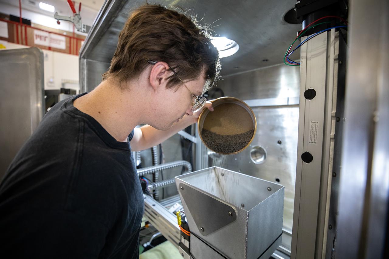 Materials engineer Thomas Lipscomb tests a 3D printer on July 28, 2022, at Swamp Works at NASA’s Kennedy Space Center in Florida, as part of the Relevant Environment Additive Construction Technology (REACT) project. Among the key objectives of the project is developing an architectural and structural design for a shelter that provides protection to habitable assets on the lunar surface. Testing REACT derives from NASA’s 2020 Announcement of Collaboration Opportunity with AI SpaceFactory – an architectural and construction technology company and winner of NASA’s 3D Printed Habitat Challenge.