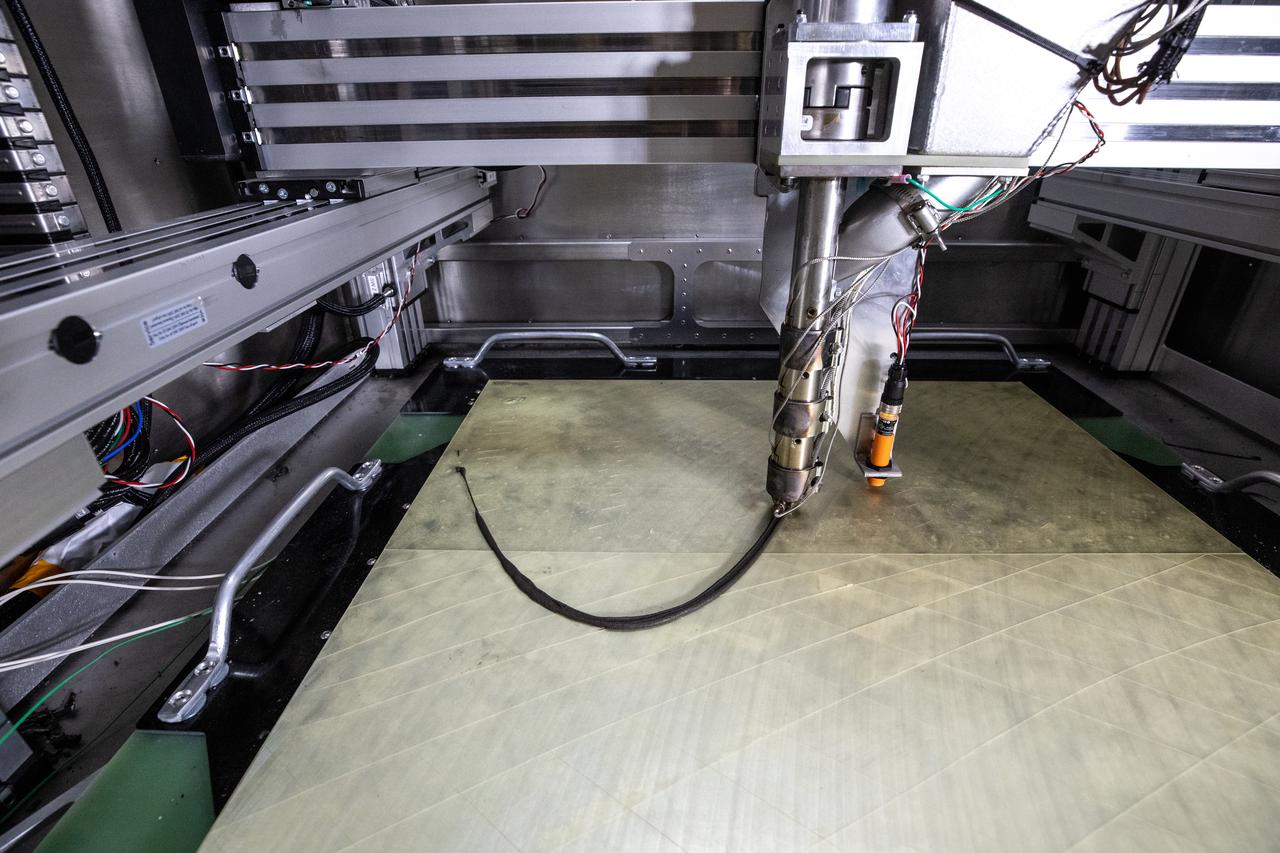 Shown is a Zero Launch Mass 3D printer on July 28, 2022, at NASA’s Kennedy Space Center’s Swamp Works. A team at the Florida spaceport tested the printer as part of the Relevant Environment Additive Construction Technology (REACT) project. Among the key objectives of the project is developing an architectural and structural design for a shelter that provides protection to habitable assets on the lunar surface. Testing REACT derives from NASA’s 2020 Announcement of Collaboration Opportunity with AI SpaceFactory – an architectural and construction technology company and winner of NASA’s 3D Printed Habitat Challenge.