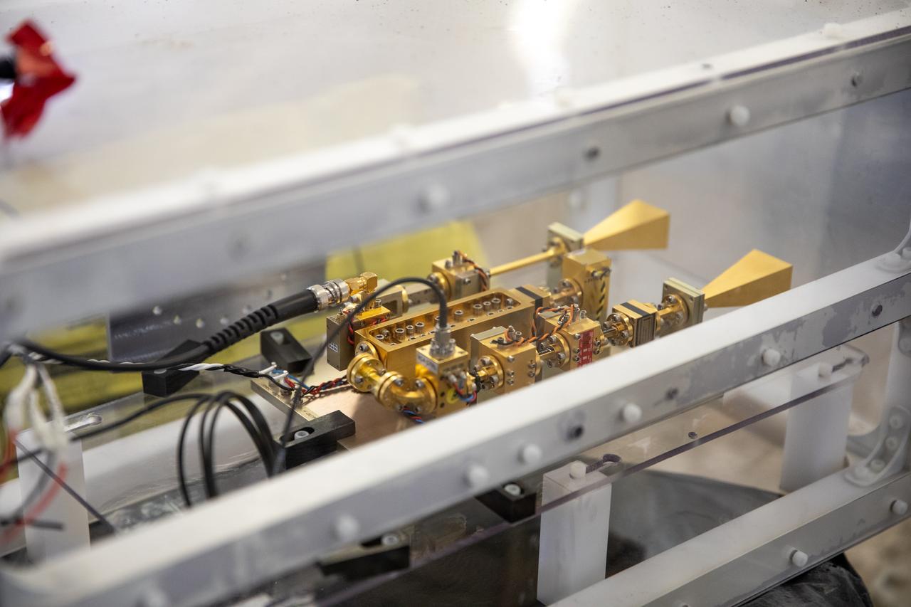 A team at NASA’s Kennedy Space Center in Florida assesses the Dust Concentration Monitor and the Millimeter Wave Doppler Radar inside a regolith bin at the Granular Mechanics and Regolith Operations (GMRO) lab at the spaceport’s Swamp Works on July 28, 2022, as part of Plume Surface Interaction (PSI) Instrumentation testing. The PSI Project is advancing both modeling and testing capabilities to understand exactly how rocket exhaust plumes affect a planetary landing site. This advanced modeling will help engineers evaluate the risks of various plumes on planetary surfaces, which will help them more accurately design landers for particular locations. 