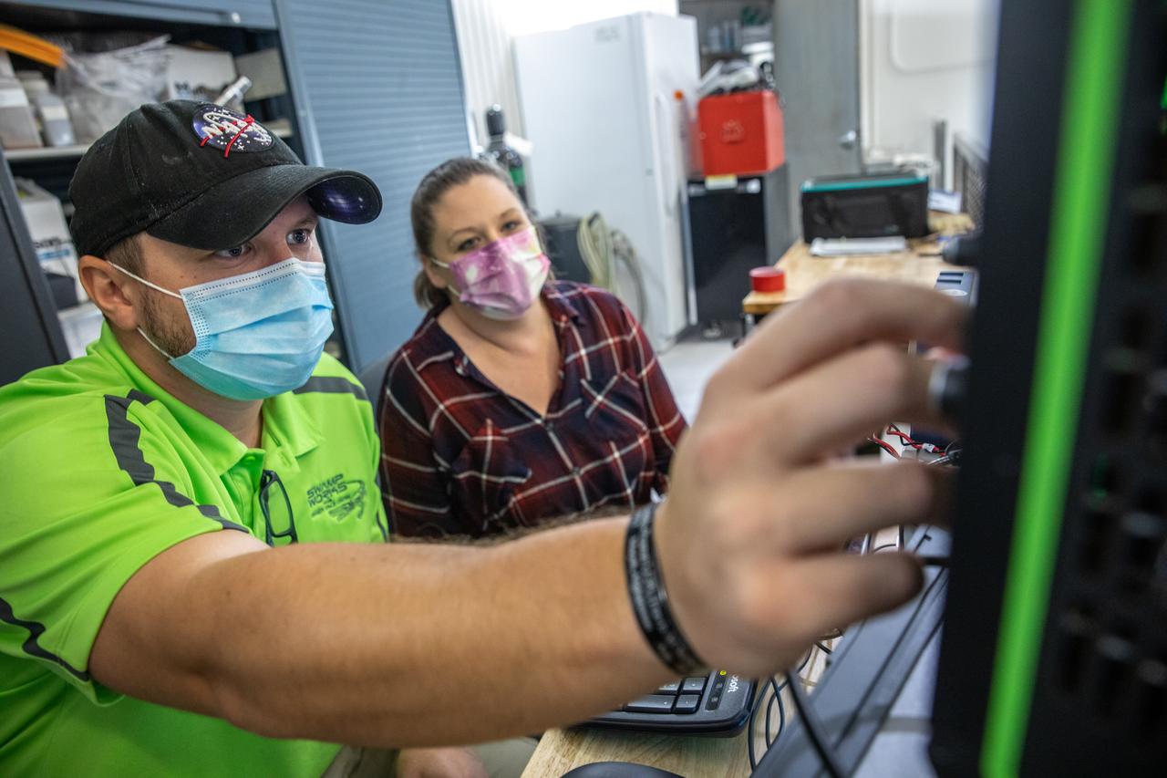A team at NASA’s Kennedy Space Center in Florida assesses the Dust Concentration Monitor and the Millimeter Wave Doppler Radar inside a regolith bin at the Granular Mechanics and Regolith Operations (GMRO) lab at the spaceport’s Swamp Works on July 28, 2022, as part of Plume Surface Interaction (PSI) Instrumentation testing. The PSI Project is advancing both modeling and testing capabilities to understand exactly how rocket exhaust plumes affect a planetary landing site. This advanced modeling will help engineers evaluate the risks of various plumes on planetary surfaces, which will help them more accurately design landers for particular locations. 
