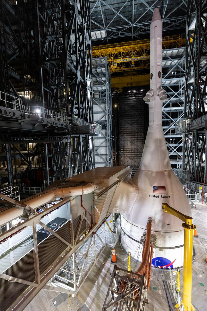 The Artemis I Orion spacecraft, secured on the Space Launch System and enclosed in its launch abort system, is in view high up in High Bay 3 of the Vehicle Assembly Building at NASA’s Kennedy Space Center in Florida on Aug. 8, 2022. Artemis I will provide a foundation for human deep space exploration and demonstrate NASA’s capability to extend human presence to the Moon and beyond. The primary goal of Artemis I is to thoroughly test the Space Launch System rocket and Orion spacecraft’s integrated systems before crewed missions. Under Artemis, NASA aims to land the first woman and first person of color on the Moon and establish sustainable lunar exploration.