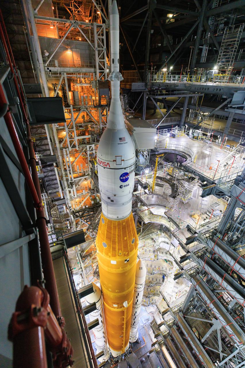 NASA’s Space Launch System and Orion spacecraft atop the mobile launcher are in view in High Bay 3 of the Vehicle Assembly Building (VAB) at the agency’s Kennedy Space Center in Florida on Tuesday, Aug. 16, 2022. All of the work platforms have been retracted in preparation for rollout to Launch Complex 39B ahead of launch of Artemis I. The crawler-transporter, driven by engineers, is under the Artemis I stack atop the mobile launcher and will carry it 4.2 miles via the crawlerway that connects the VAB to the launch pad. The agency’s Artemis I flight test is scheduled to liftoff on Monday, Aug. 29. The first in a series of increasingly complex missions, Artemis I will provide a foundation for human deep space exploration and demonstrate our commitment and capability to extend human presence to the Moon and beyond. The primary goal of Artemis I is to thoroughly test the integrated systems before crewed missions by launching Orion atop the SLS rocket, operating the spacecraft in a deep space environment, testing Orion’s heat shield, and recovering the crew module after reentry, descent, and splashdown.