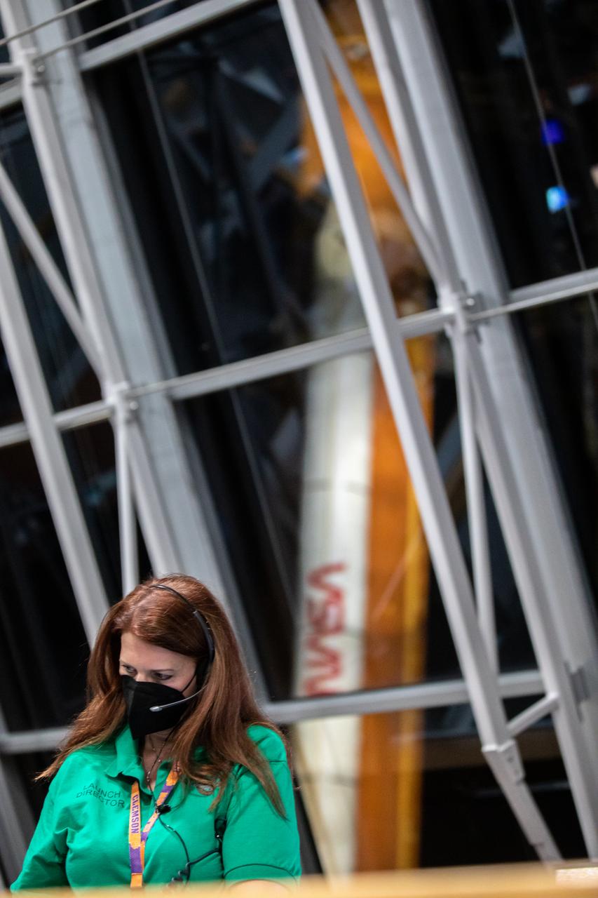 NASA Launch Director Charlie Blackwell-Thompson monitors rollout operations from her console as the agency’s Space Launch System (SLS) rocket with the Orion spacecraft atop a mobile launcher is visible through the windows of Firing Room 1 in the Rocco A. Petrone Launch Control Center as it rolls out of High Bay 3 of the Vehicle Assembly Building to Launch Complex 39B, on Tuesday, Aug. 16, 2022, ahead of the agency’s Artemis I flight test. The fully stacked and integrated SLS rocket and Orion spacecraft is scheduled to liftoff on Monday, Aug. 29. The first in a series of increasingly complex missions, Artemis I will provide a foundation for human deep space exploration and demonstrate our commitment and capability to extend human presence to the Moon and beyond. The primary goal of Artemis I is to thoroughly test the integrated systems before crewed missions by launching Orion atop the SLS rocket, operating the spacecraft in a deep space environment, testing Orion’s heat shield, and recovering the crew module after reentry, descent, and splashdown. In later missions, NASA will land the first woman and the first person of color on the surface of the Moon, paving the way for a long-term lunar presence and serving as a steppingstone on the way to Mars.