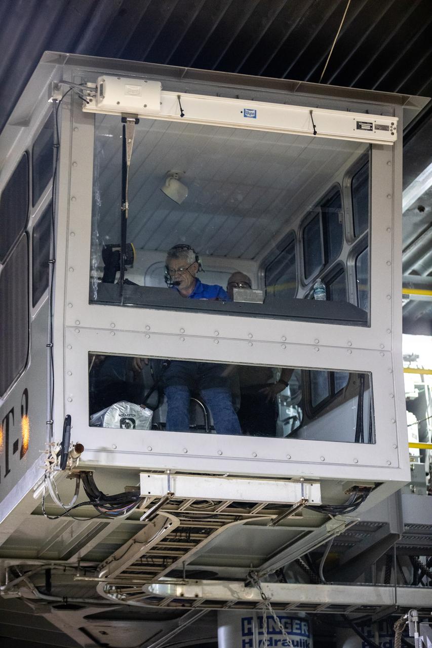 Sam Dove, crawler-transporter operations engineer and driver, Jacobs Engineering, is seen inside the operator cab of the crawler-transporter during rollout operations for NASA’s Space Launch System and Orion spacecraft at the agency’s Kennedy Space Center in Florida on Tuesday, Aug. 16, 2022. The crawler-transporter is under the Artemis I stack atop the mobile launcher and will carry it 4.2 miles via the crawlerway that connects the VAB to the launch pad. The agency’s Artemis I flight test is scheduled to liftoff on Monday, Aug. 29. The first in a series of increasingly complex missions, Artemis I will provide a foundation for human deep space exploration and demonstrate our commitment and capability to extend human presence to the Moon and beyond. The primary goal of Artemis I is to thoroughly test the integrated systems before crewed missions by launching Orion atop the SLS rocket, operating the spacecraft in a deep space environment, testing Orion’s heat shield, and recovering the crew module after reentry, descent, and splashdown.