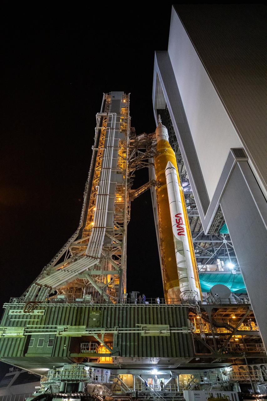 NASA’s Space Launch System (SLS) rocket with the Orion spacecraft aboard is seen atop a mobile launcher as it rolls out from the Vehicle Assembly Building on its 4.2-mile journey on the crawlerway to Launch Complex 39B on Tuesday, Aug. 16, 2022, at NASA’s Kennedy Space Center in Florida. As part of the agency’s Artemis I flight test, the fully stacked and integrated SLS rocket and Orion spacecraft is scheduled to liftoff on Monday, Aug. 29. The first in a series of increasingly complex missions, Artemis I will provide a foundation for human deep space exploration and demonstrate our commitment and capability to extend human presence to the Moon and beyond. The primary goal of Artemis I is to thoroughly test the integrated systems before crewed missions by launching Orion atop the SLS rocket, operating the spacecraft in a deep space environment, testing Orion’s heat shield, and recovering the crew module after reentry, descent, and splashdown.